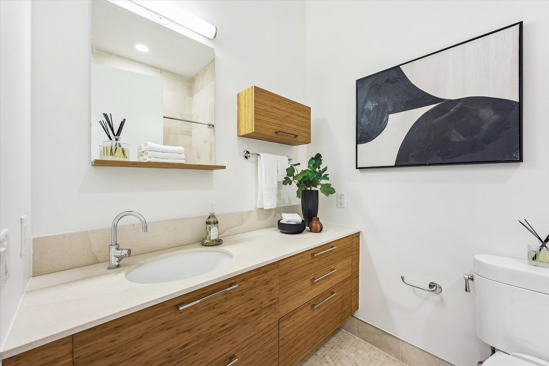 [Bath for Bedroom Two] En-suite bathroom with floating vanity and tub/shower combination.