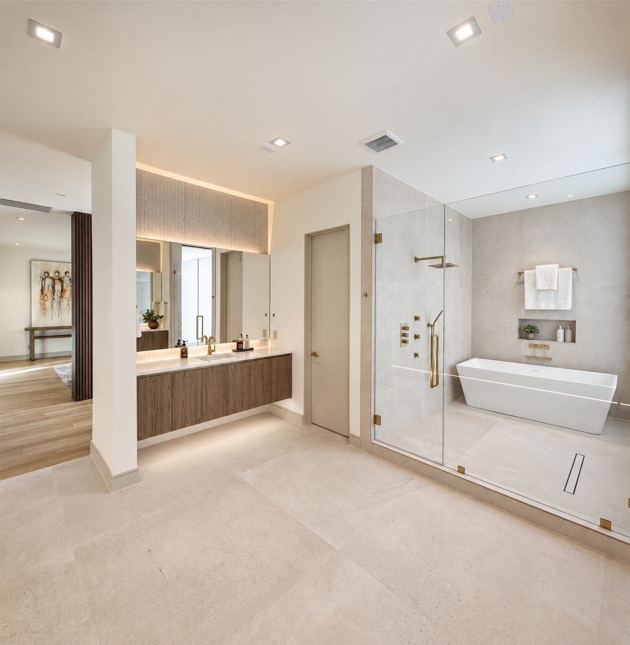 This is not just a primary bath, its a private wellness retreat.  Dual vanities create beautifully independent spaces, while a dramatic glass-enclosed wet room places the soaking tub an oversized shower together in their ownspa-like sanctuary.