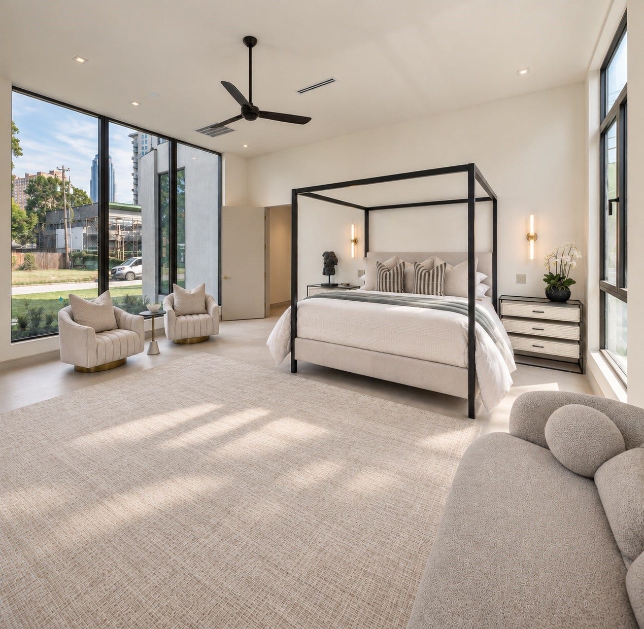 A serene first-floor primary suite where soaring ceilings and walls of glass create an airy sense of luxury. Front-yard views bring the outdoors in, while the generous proportions offer the perfect setting to unwind in privacy and comfort.