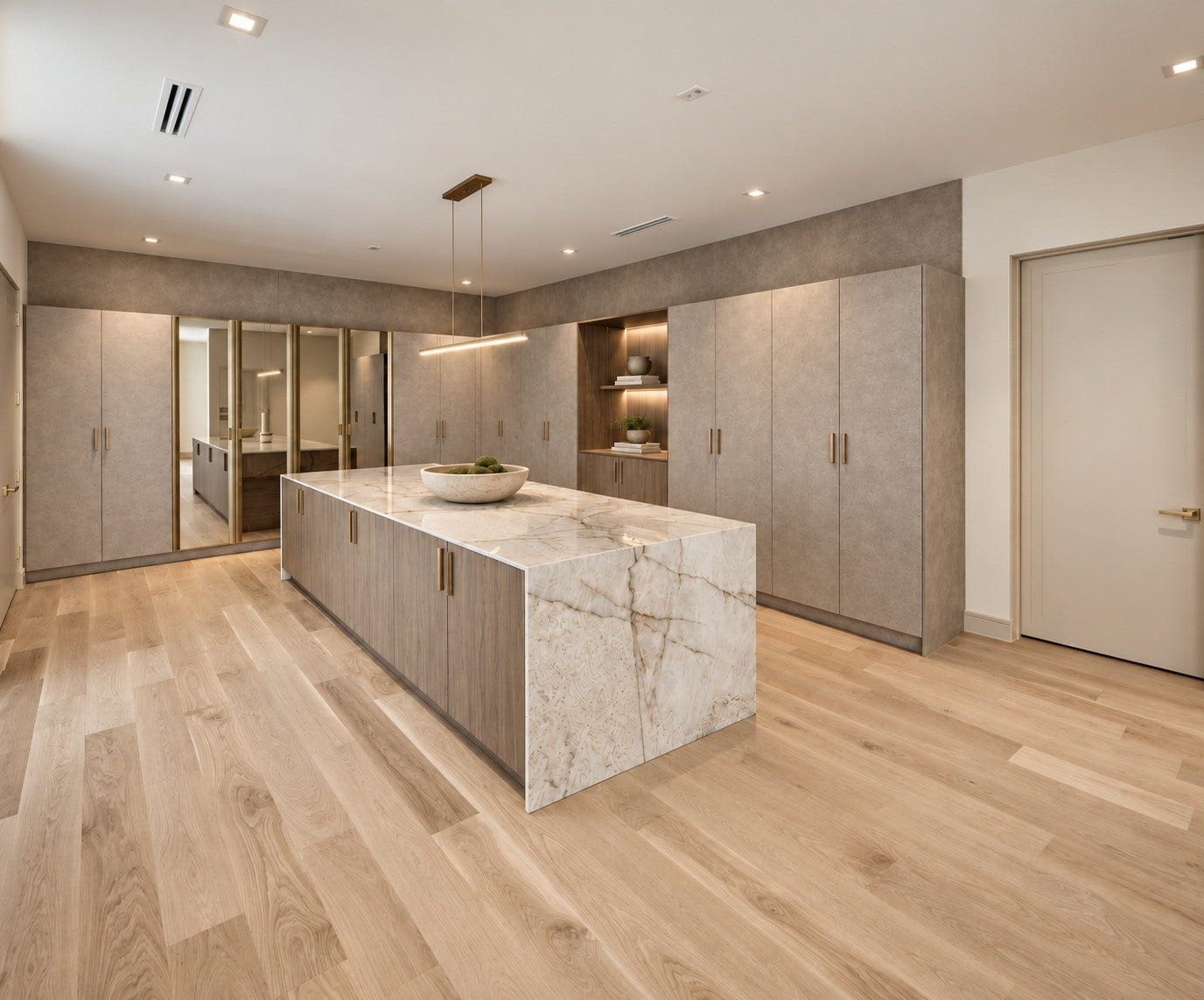 Not simply a primary closet, but a private fashion suite. Part dressing room , part luxury boutique and entirely indulgent. A dramatic stone island takes center stage, while walls of custom cabinetry conceal dedicated shoe storage, wardrobe organization and storage galore. Designed to turn getting dressed into an experience, this is where every piece has its place and everyday routines feel anything but ordinary. Additional concealed extra storage within the main dressing area.