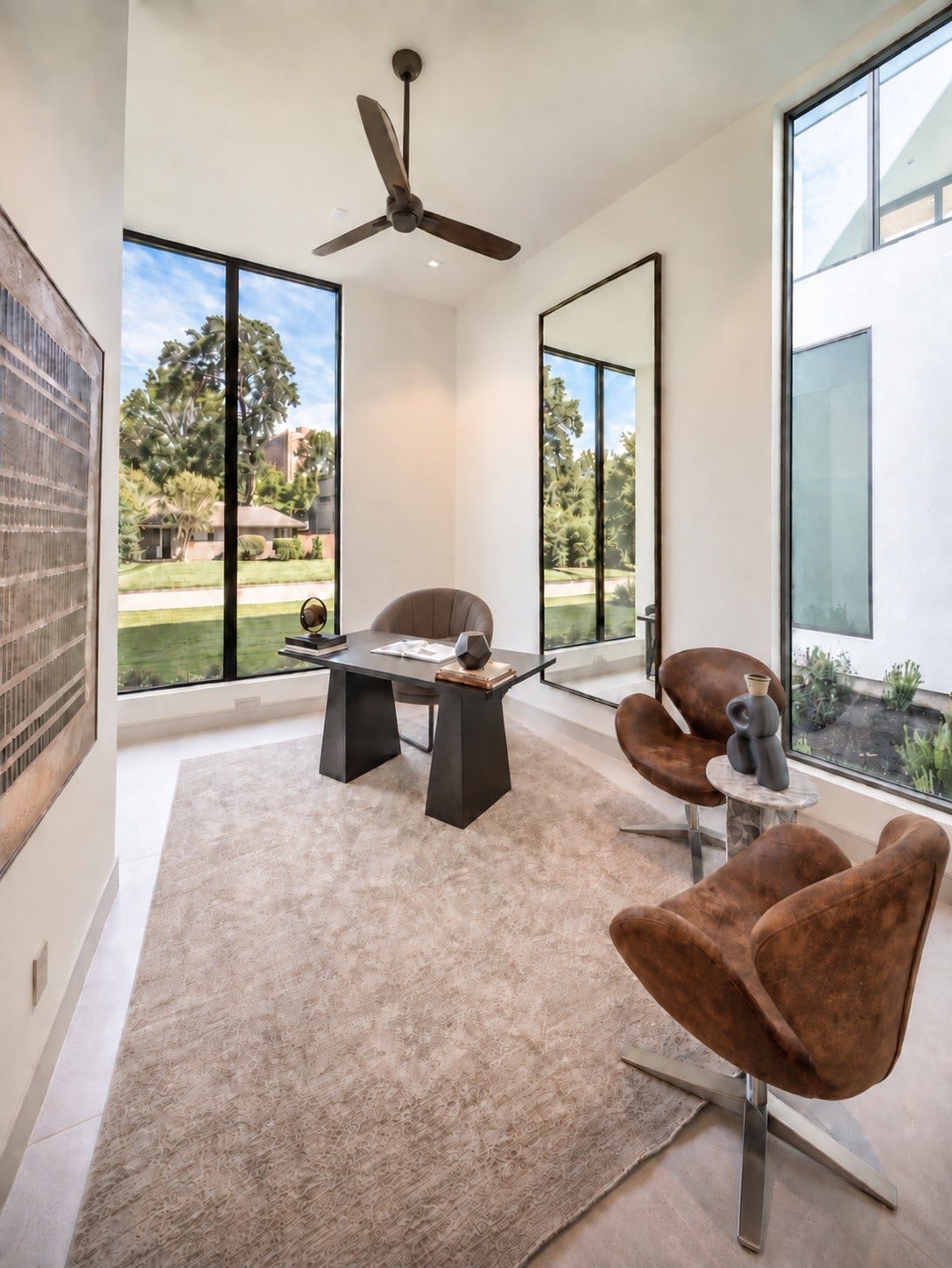 A home office that makes working from home feel anything but routine. Walls of glass frame serene outdoor views and fill the space with natural light, creating an inspiration for setting for calls, meetings or quiet productivity.