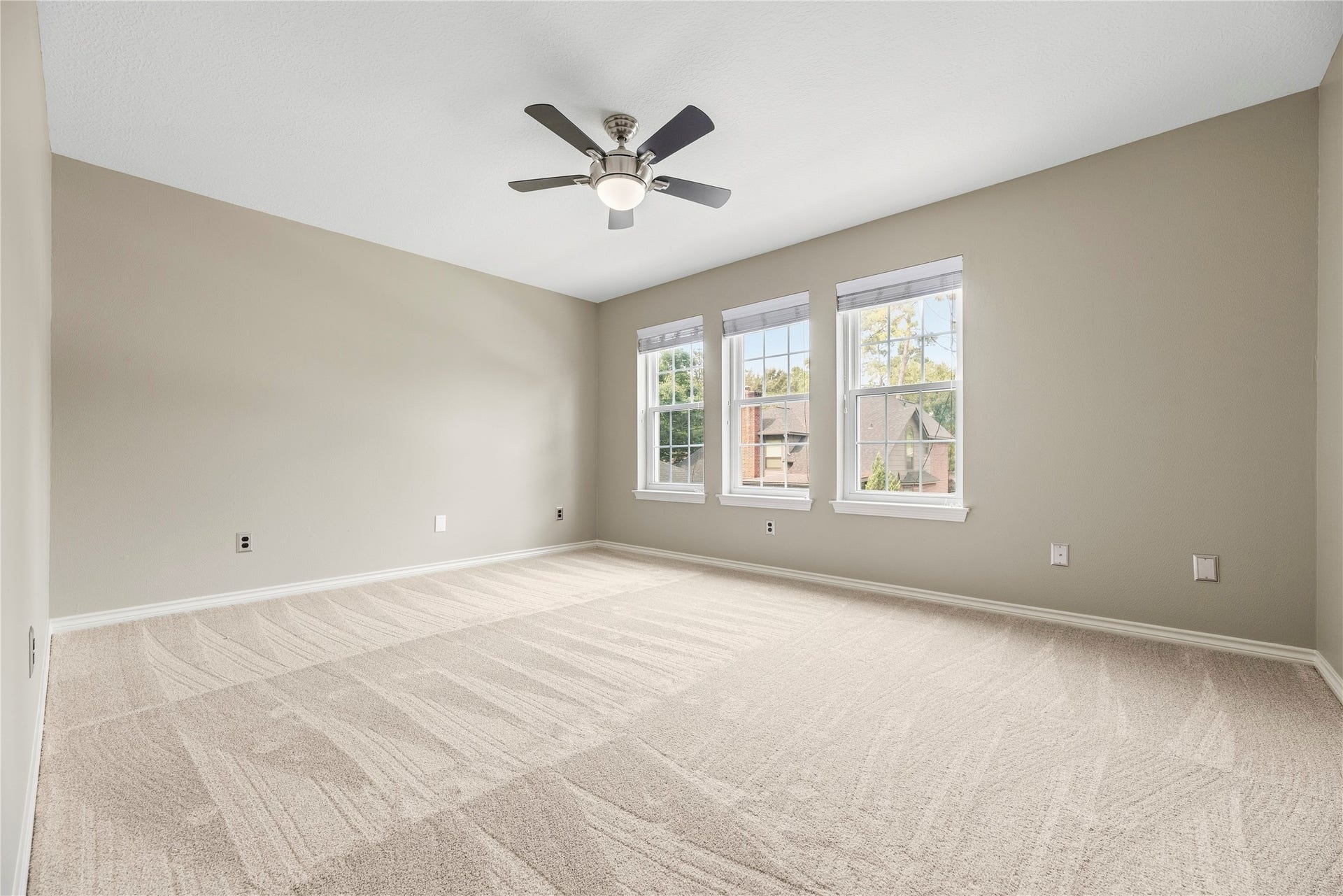 13114 S Winesap Lane, Cypress, TX 77429 Spacious secondary bedroom with plush carpeting, abundant natural light from large windows, and a modern ceiling fan.