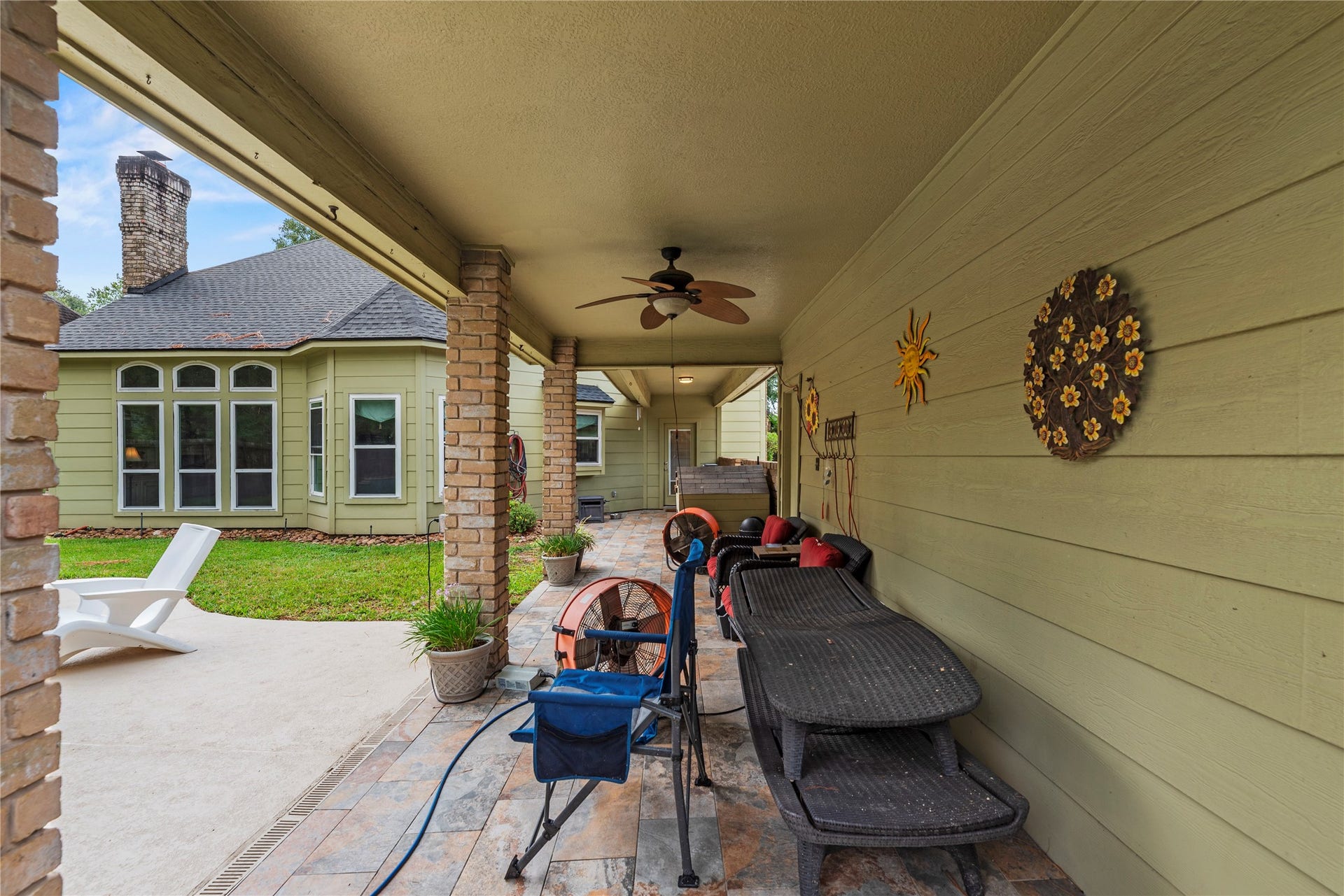 13114 S Winesap Lane, Cypress, TX 77429 Charming covered patio with ceiling fan and inviting outdoor seating.