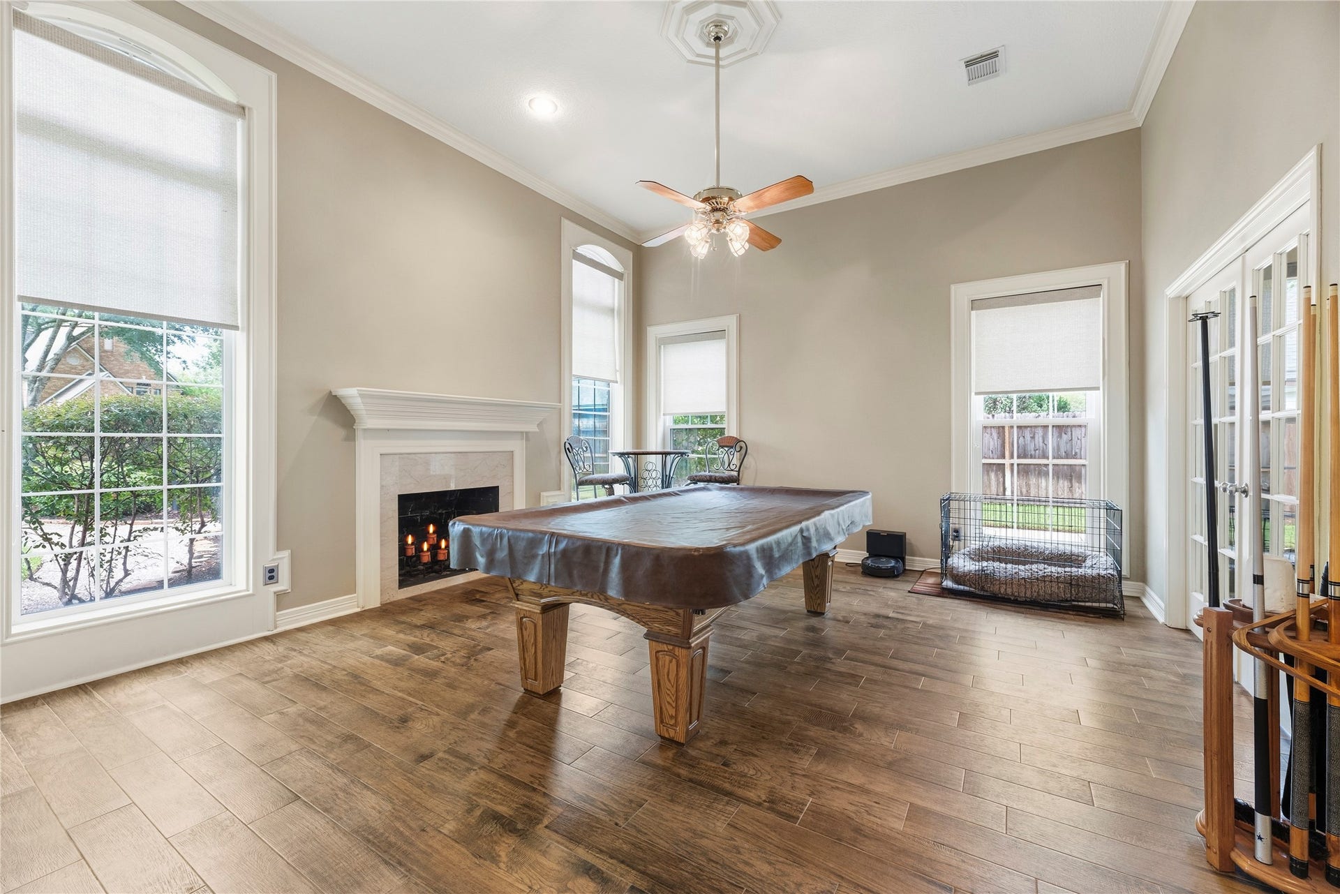 13114 S Winesap Lane, Cypress, TX 77429 Elegant formal living room with hardwood floors, a cozy fireplace, and large windows offering plenty of natural light.