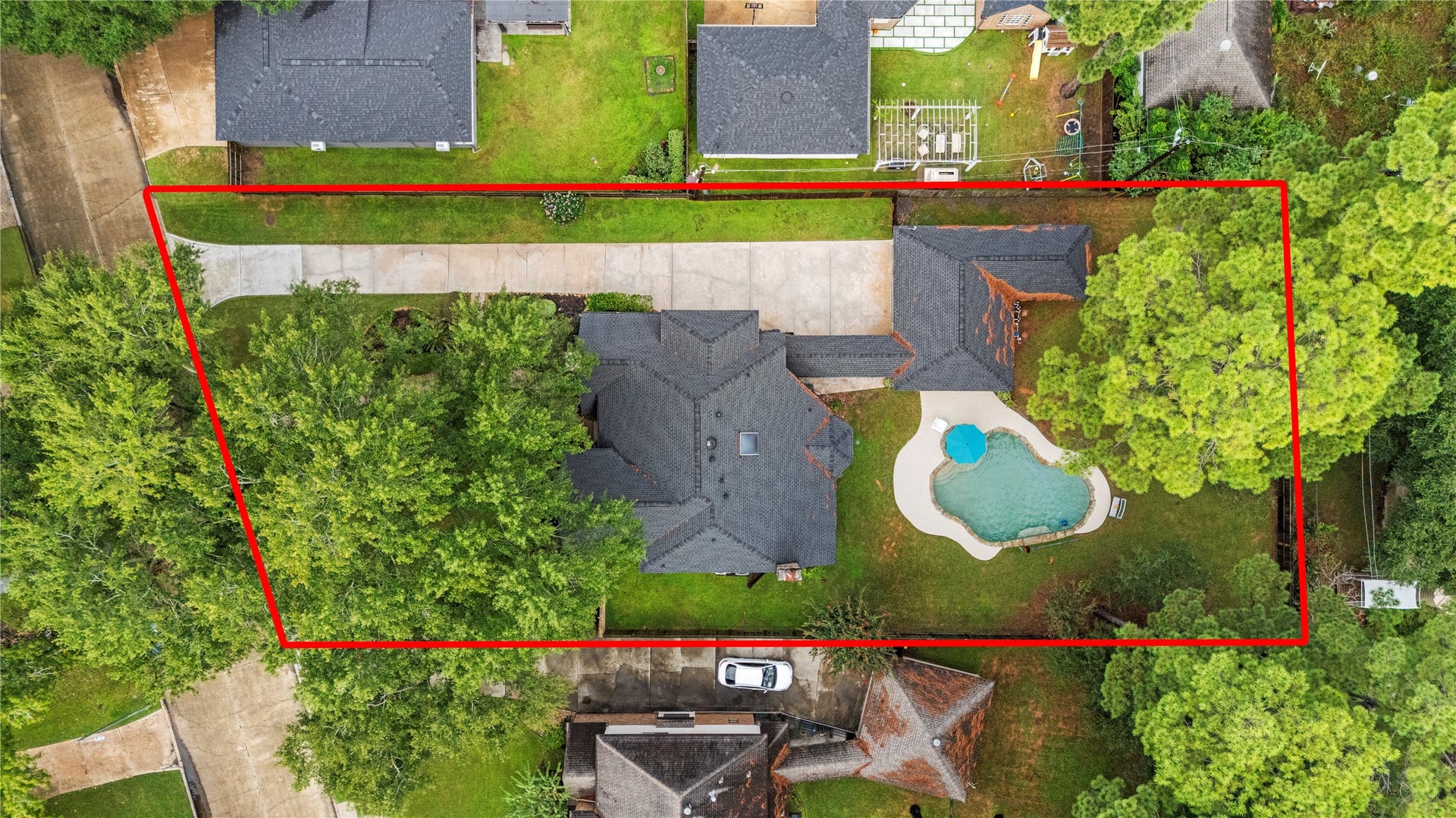 13114 S Winesap Lane, Cypress, TX 77429 Expansive property with a private pool, lush greenery, and ample driveway space, perfect for luxurious outdoor living and entertaining.