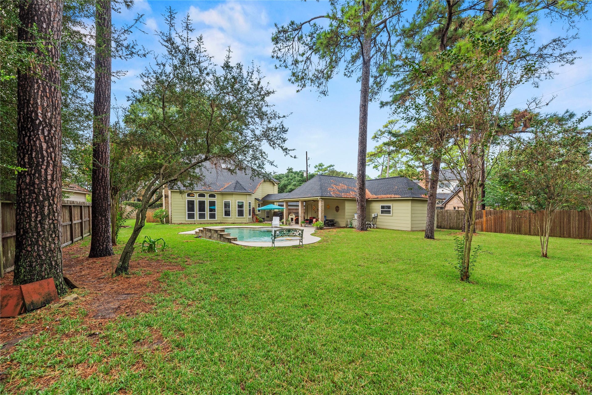 13114 S Winesap Lane, Cypress, TX 77429 Spacious backyard retreat featuring a lush lawn with mature trees.