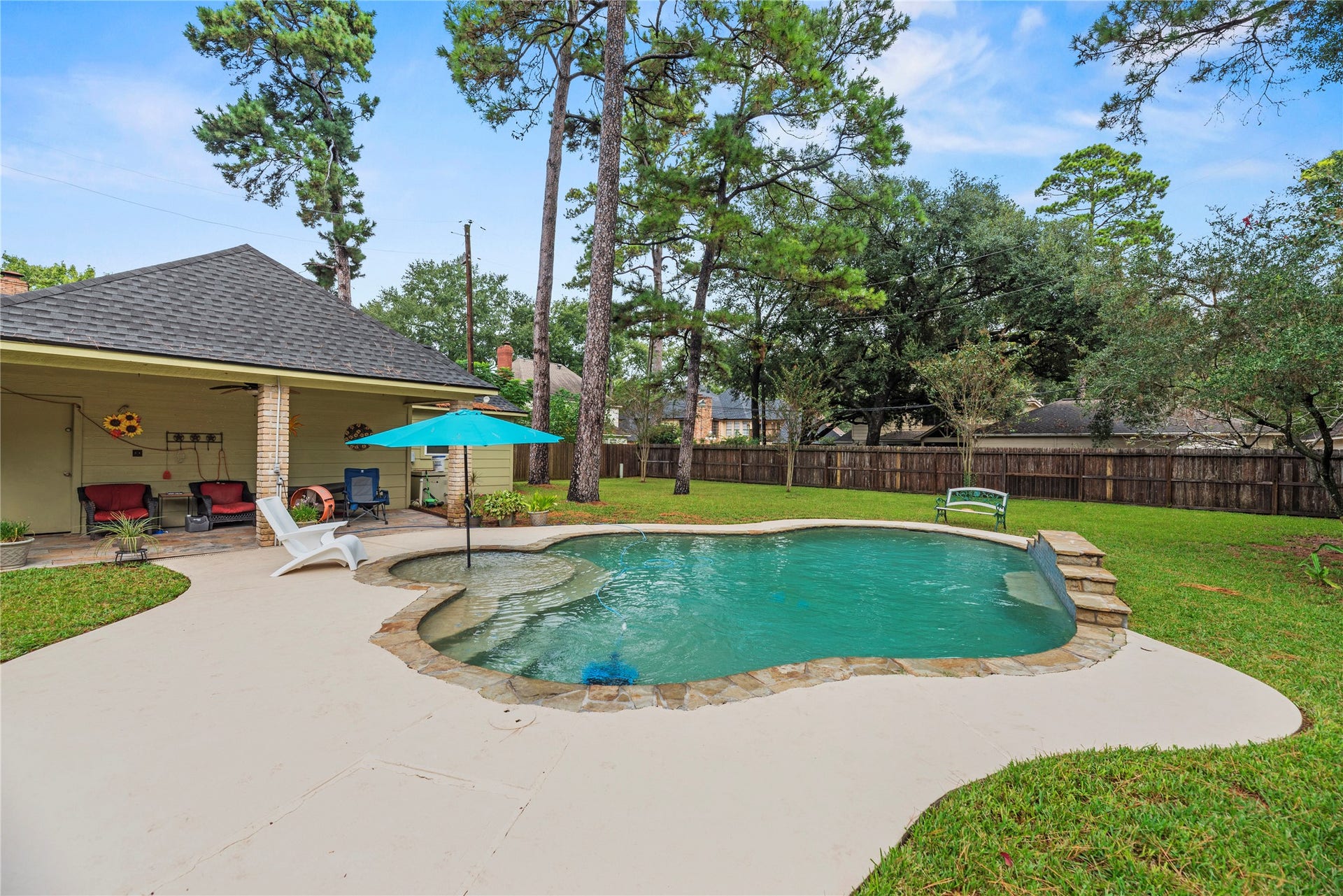 13114 S Winesap Lane, Cypress, TX 77429 Sparkling pool, surrounded by lush greenery and a spacious patio area perfect for relaxation and entertaining.