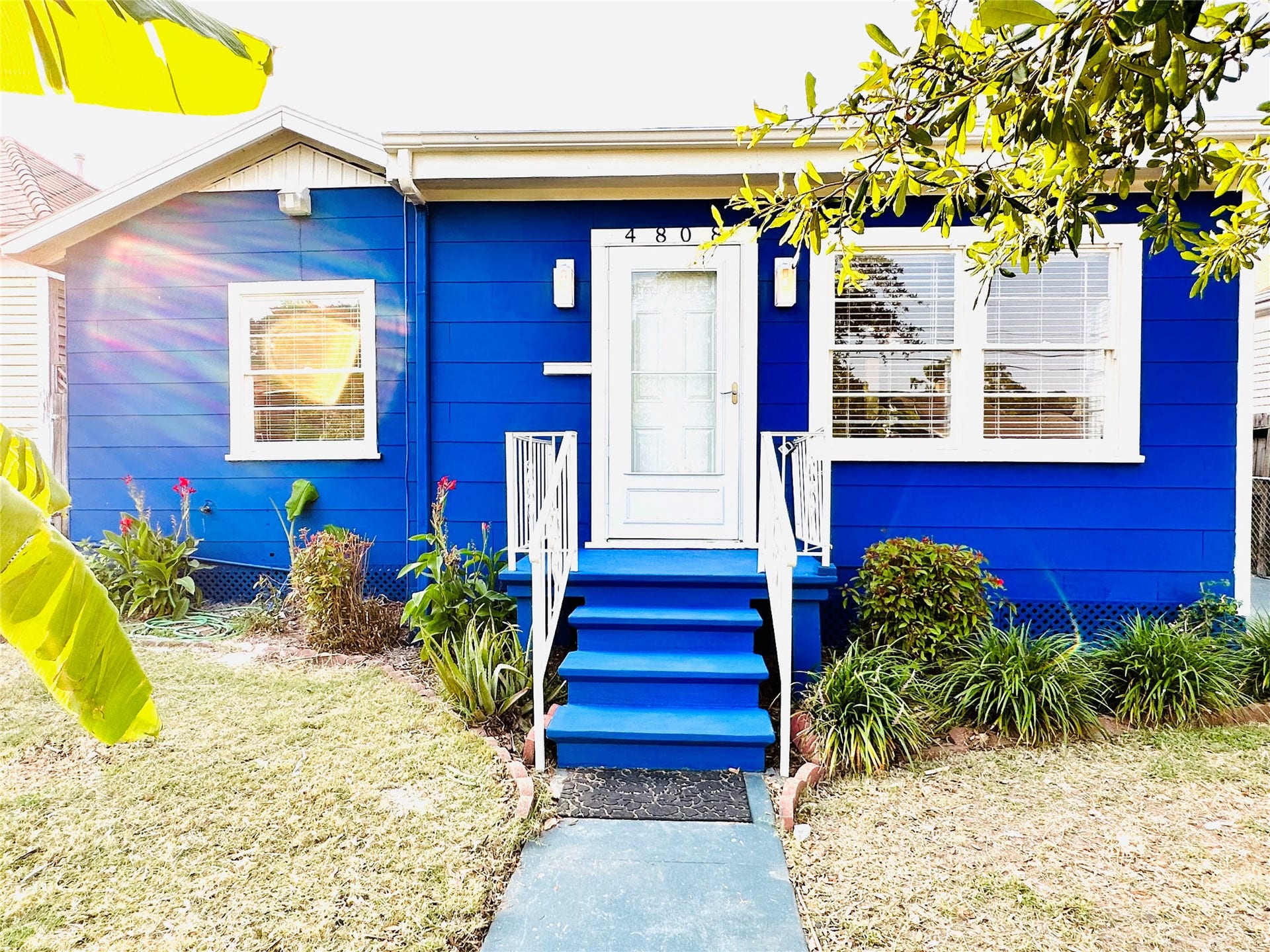4808 Avenue S, #A, Galveston, TX 77551 Charming and vibrant front exterior with welcoming steps and lush landscaping.