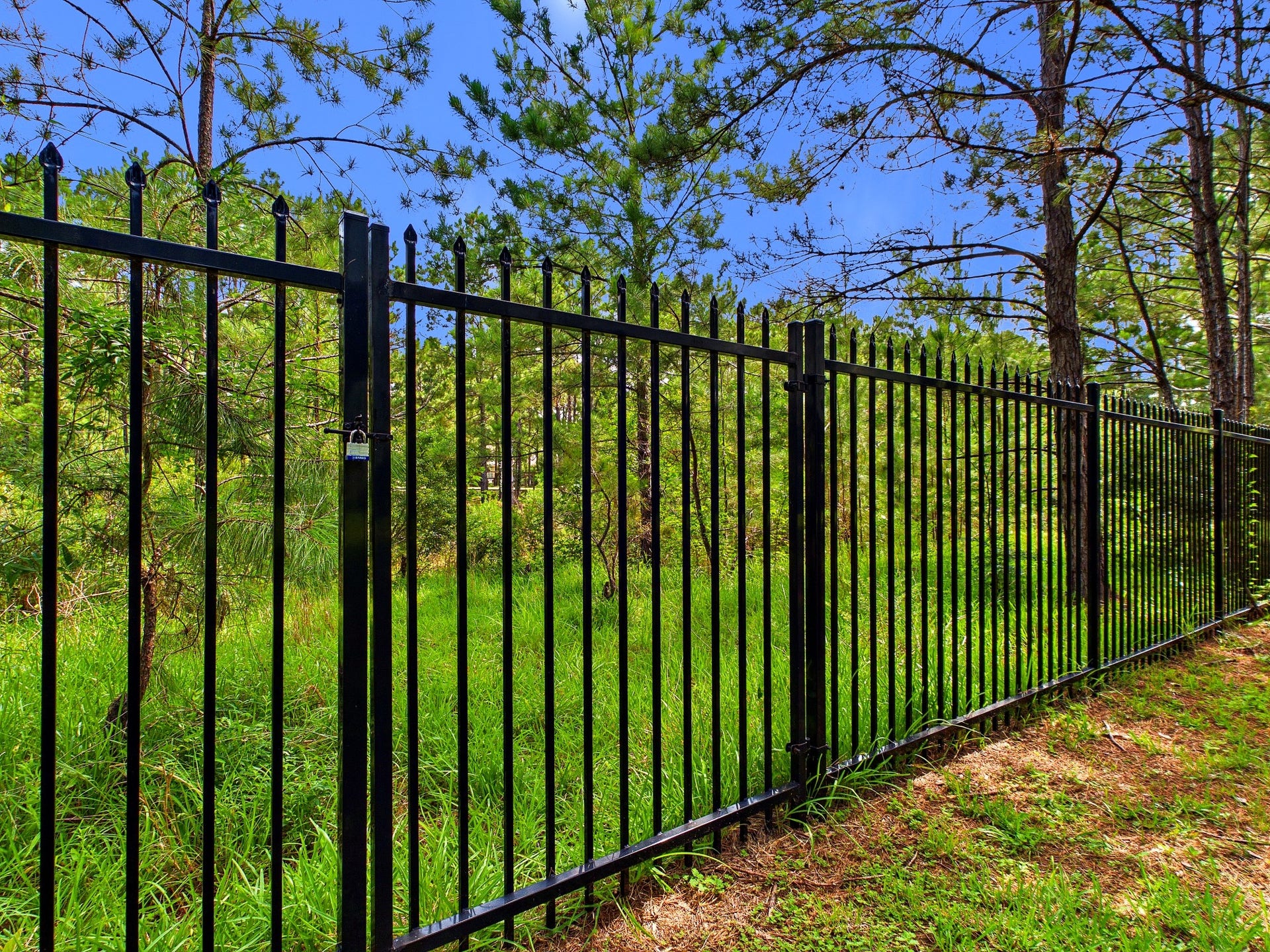 19521 Desna Drive, Porter, TX 77365 A sturdy black metal fence with a gate at the back of the property leads to the canal. A lush, green wooded area, offering natural beauty. Enjoy leisurely activities with this canal waterway that leads to the community lake.