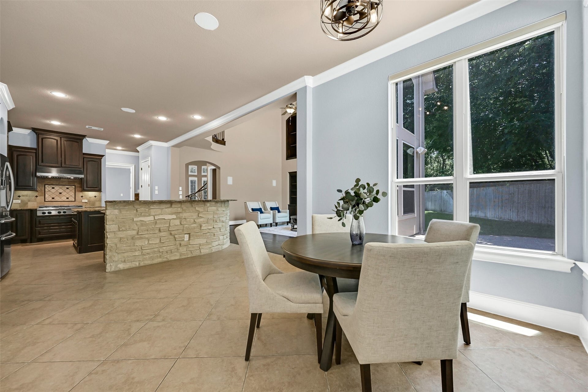 2304 Halls Creek Court, Friendswood, TX 77546 With natural light streaming in from multiple walls of windows, the breakfast area feels both open and inviting while remaining seamlessly connected to the kitchen and family room, making it ideal for casual dining and morning coffee overlooking the backyard.