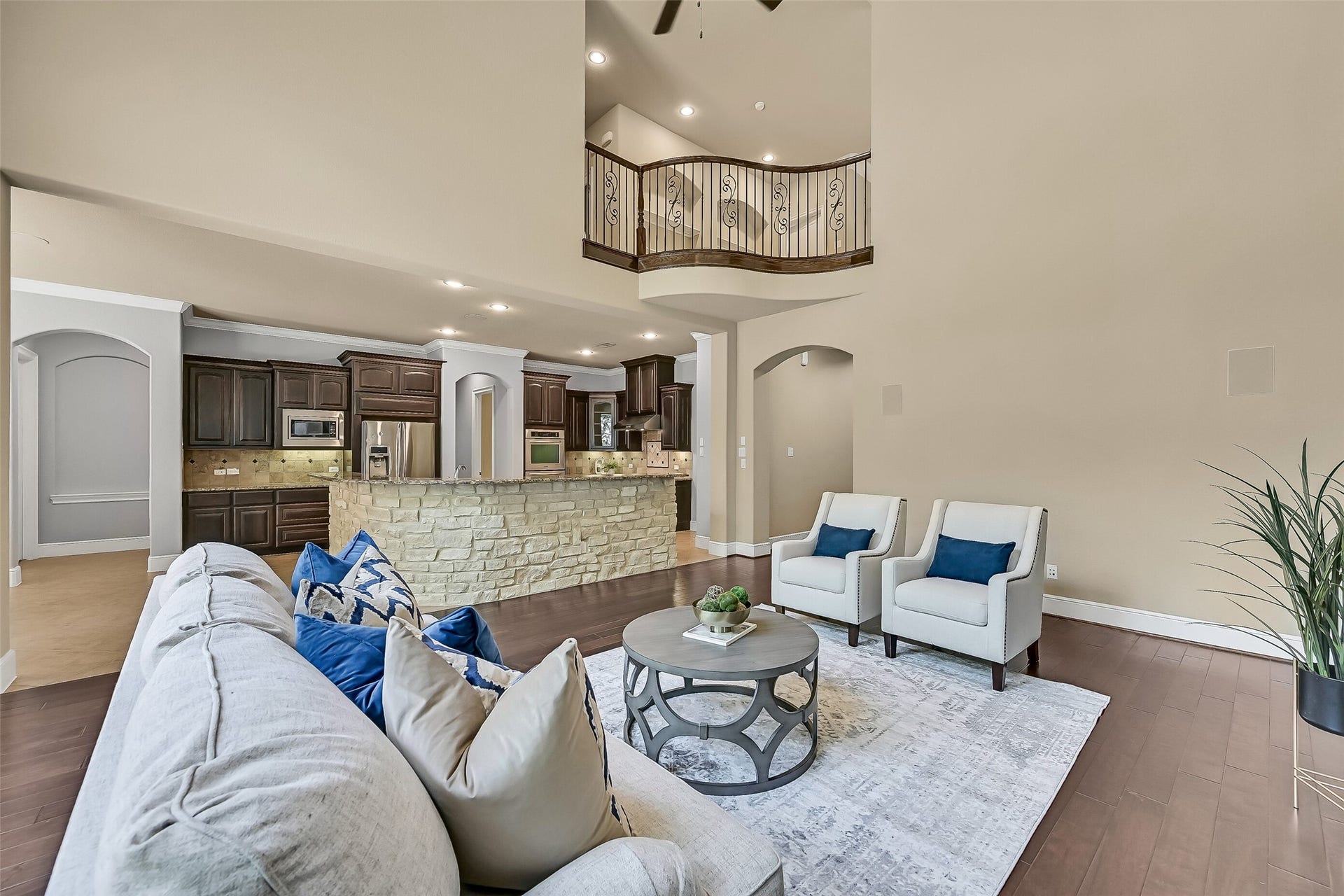 2304 Halls Creek Court, Friendswood, TX 77546 From the family room, the homes open-concept layout really comes into focus with sightlines into the kitchen, breakfast room, and upstairs landing, while the sweeping stone breakfast bar creates a natural gathering space at the heart of the home.