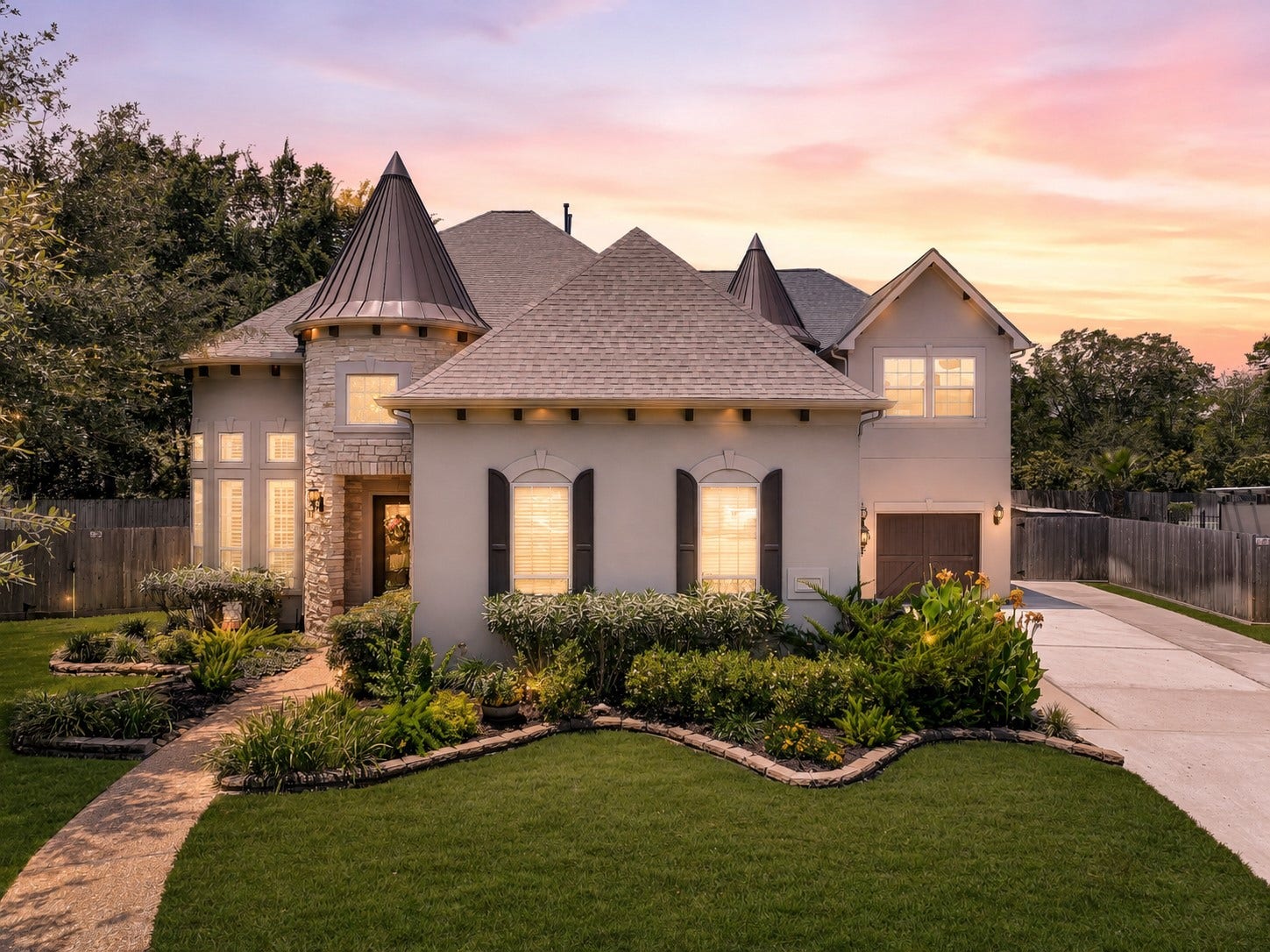 2304 Halls Creek Court, Friendswood, TX 77546 Tucked away on a beautifully landscaped cul-de-sac lot in West Ranch, this custom stucco home immediately stands apart with its stone turret accents, dramatic metal rooflines, carriage-style garage doors, lantern lighting, and meticulously maintained grounds that create unforgettable curb appeal from the street.