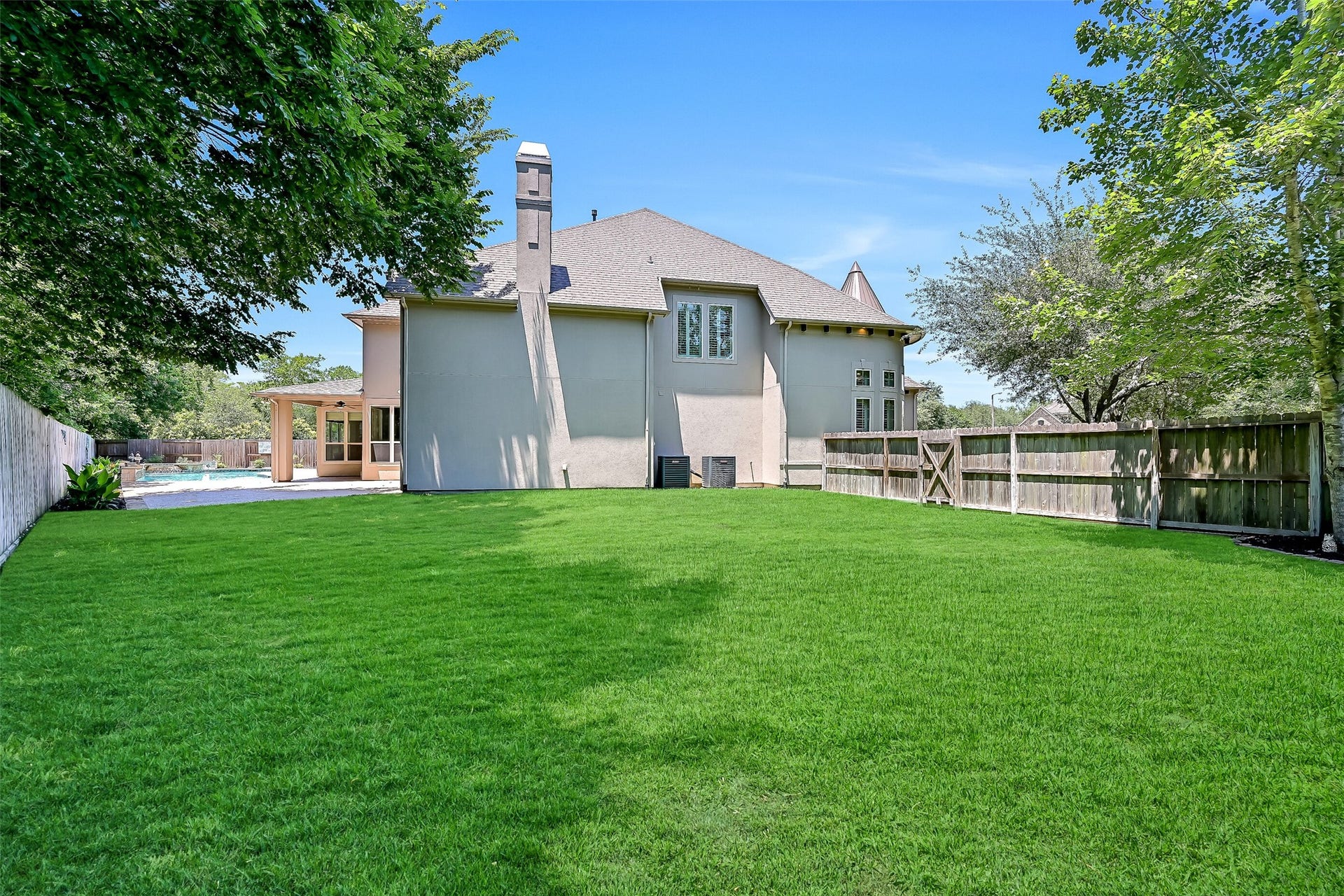 2304 Halls Creek Court, Friendswood, TX 77546 Set on a pie-shaped lot, the backyard also features a large side yard with lush green space, full irrigation system, and plenty of room for pets, play, or future outdoor additions.