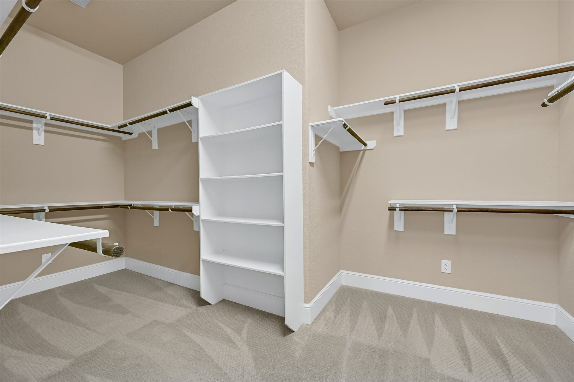 2304 Halls Creek Court, Friendswood, TX 77546 One of two enormous walk-in closets in the owners suite offers extensive hanging space, built-in shelving, and room for seasonal storage, making organization effortless while complementing the suites impressive scale.