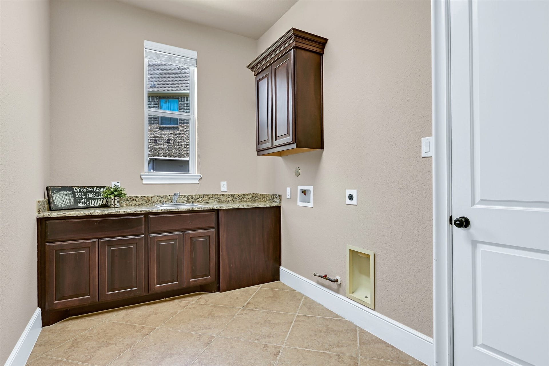 2304 Halls Creek Court, Friendswood, TX 77546 Just off of the kitchen, the spacious utility room offers a granite folding counter with a utility sink, upper cabinetry, tile flooring, and space for a full-size washer and dryer. The door opens to the single bay garage space that's perfectly suited for parking, storage, or a home gym.