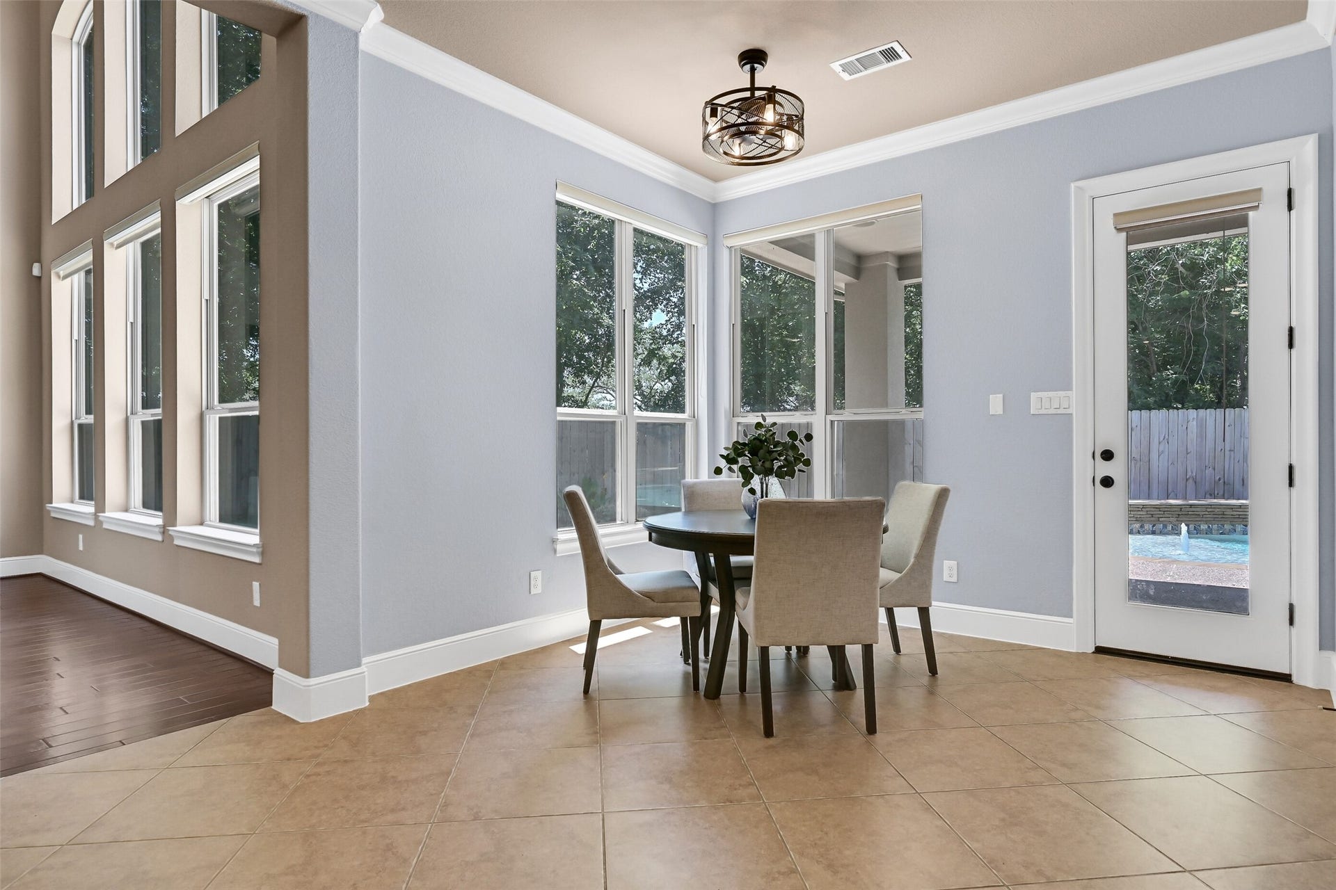 2304 Halls Creek Court, Friendswood, TX 77546 The breakfast room is surrounded by windows overlooking the backyard and pool area, creating a bright and cheerful casual dining space with direct access to the covered patio through the 8-foot glass door.