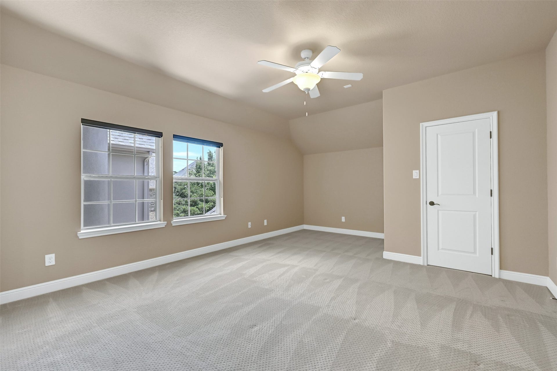 2304 Halls Creek Court, Friendswood, TX 77546 One of three spacious upstairs secondary bedrooms, this oversized retreat features plush carpet, elevated ceilings, abundant natural light, and a private en suite bath for added comfort and privacy.