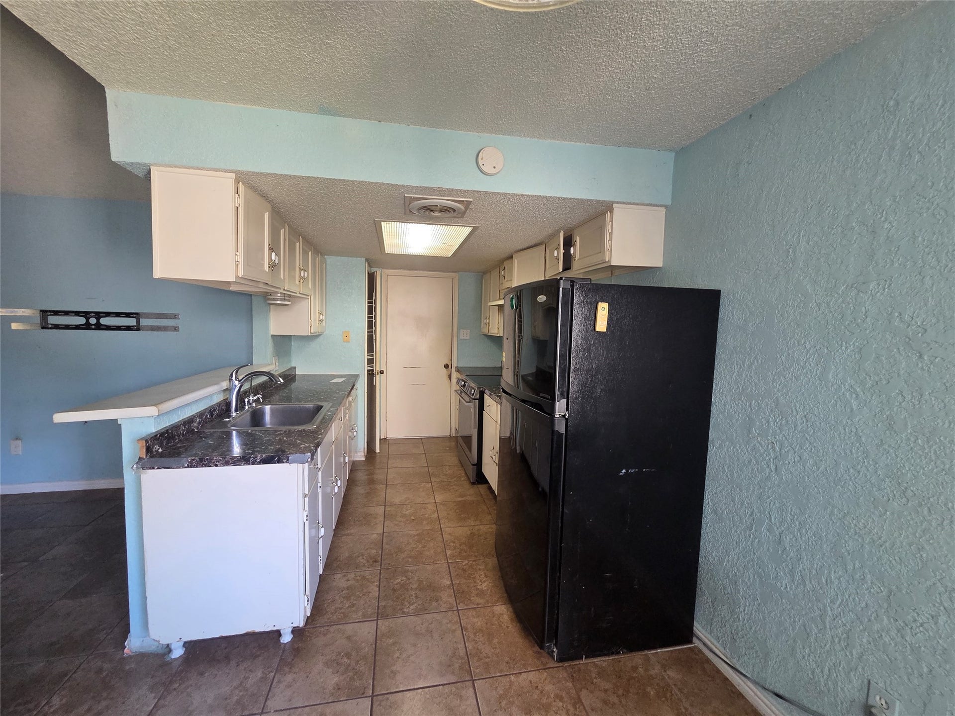 View of kitchen, needs some TLC.
