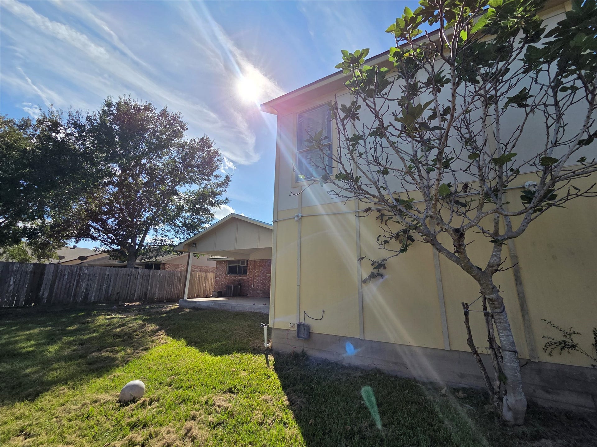 One view of back of seperate studio apartment and patio.