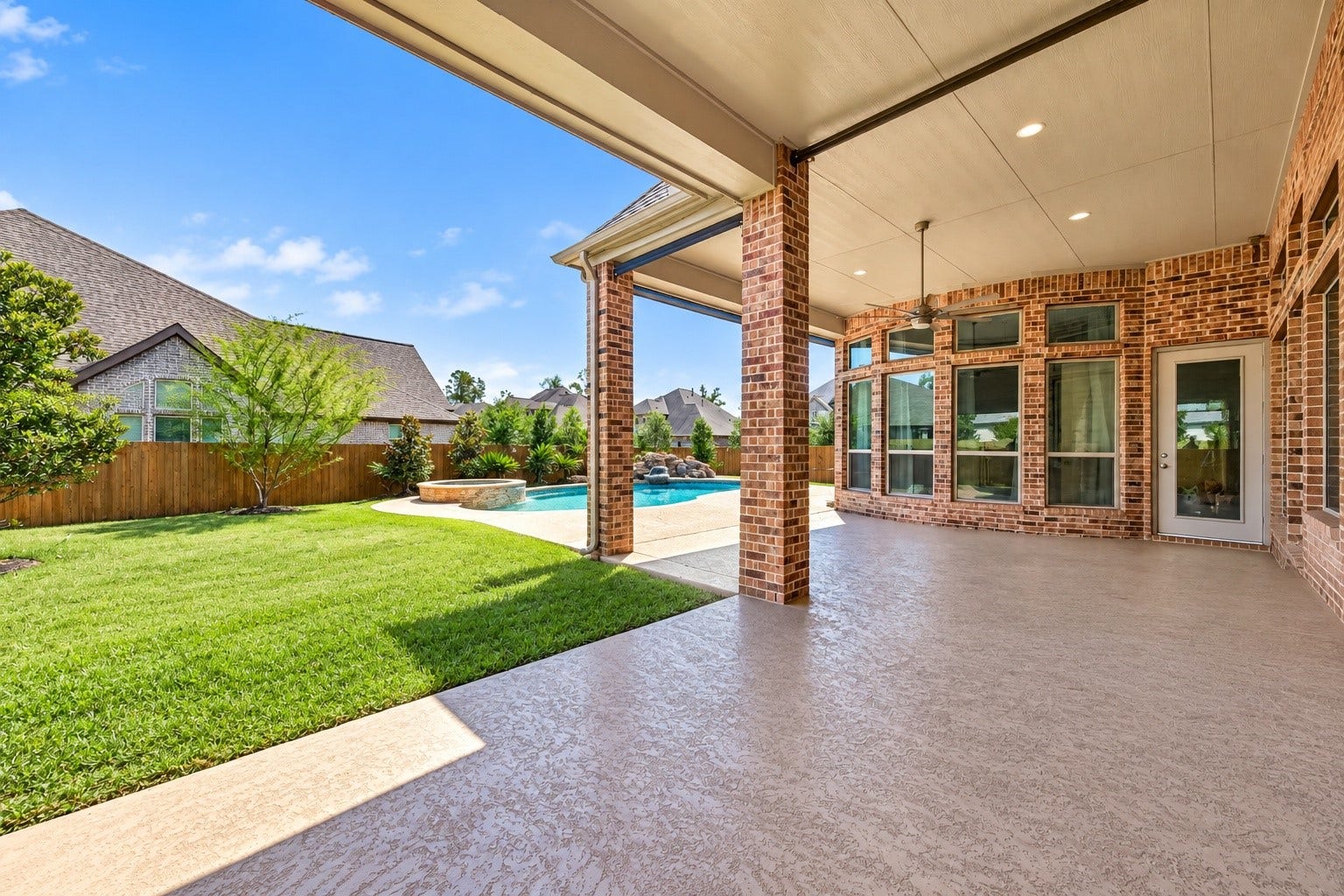 18902 Carson Glen Drive, New Caney, TX 77357 Backyard patio with aftey gate removed to show different perspective