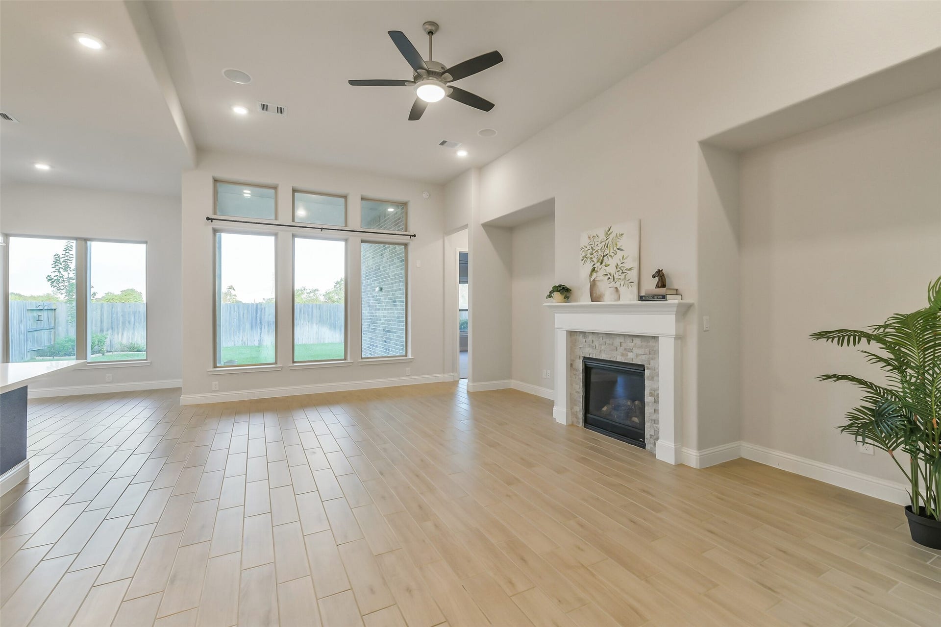 20330 Rose Gray Lane, Tomball, TX 77377 This living room features a gas fireplace, plenty of natural light and beautiful tile flowing throughout the living and kitchen areas.