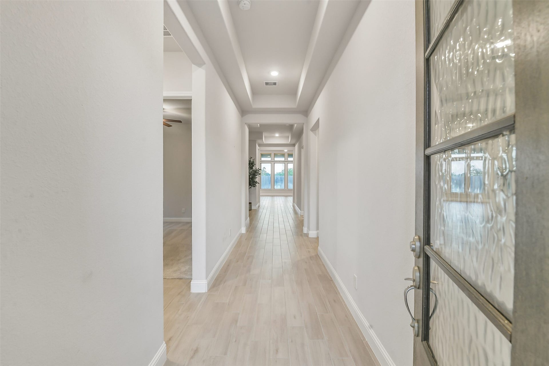 20330 Rose Gray Lane, Tomball, TX 77377 A wood and glass door open to a beautiful hallway entry.