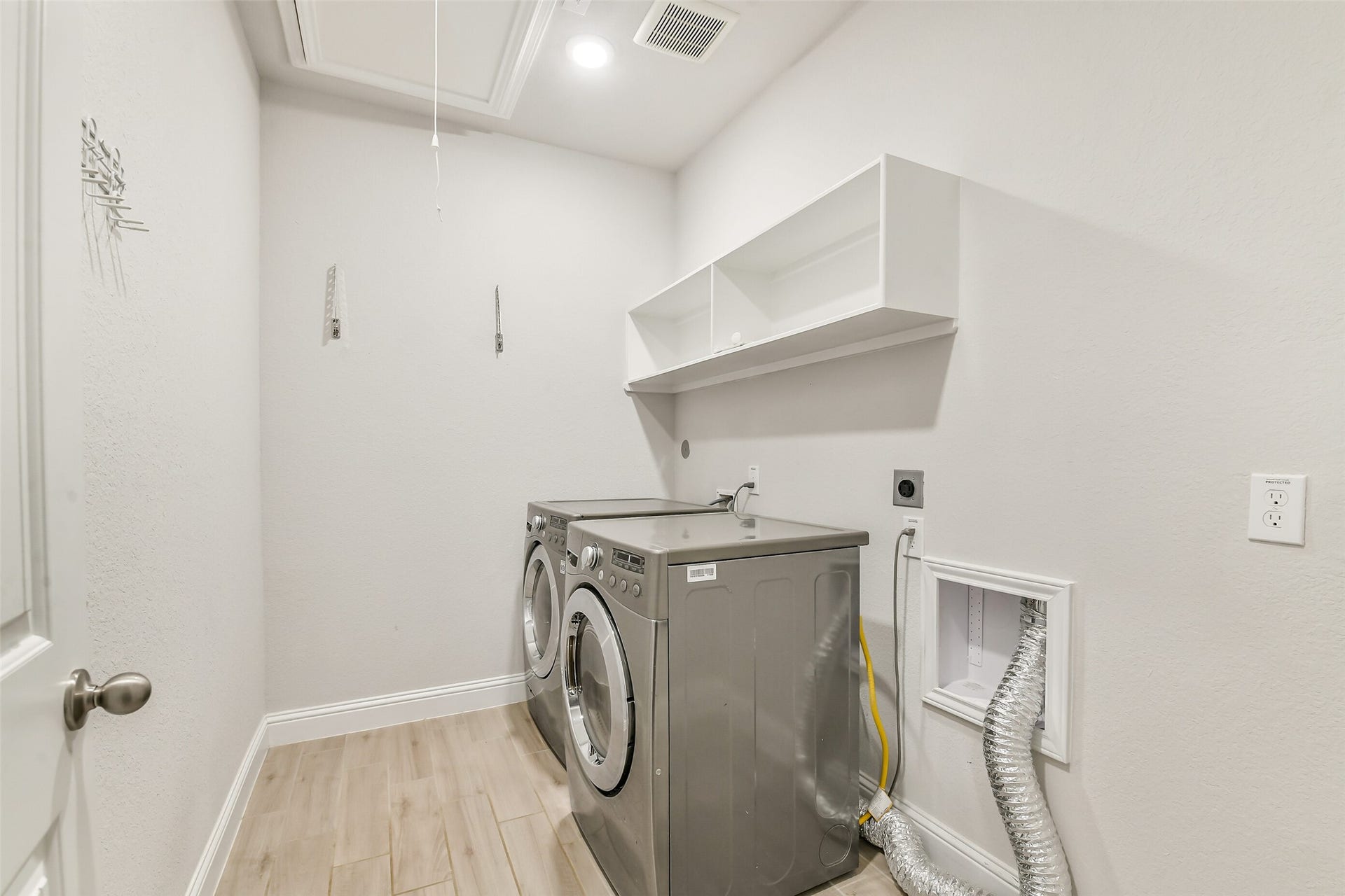 20330 Rose Gray Lane, Tomball, TX 77377 This laundry room has plenty of room for a full sized washer and dryer as well as storage.