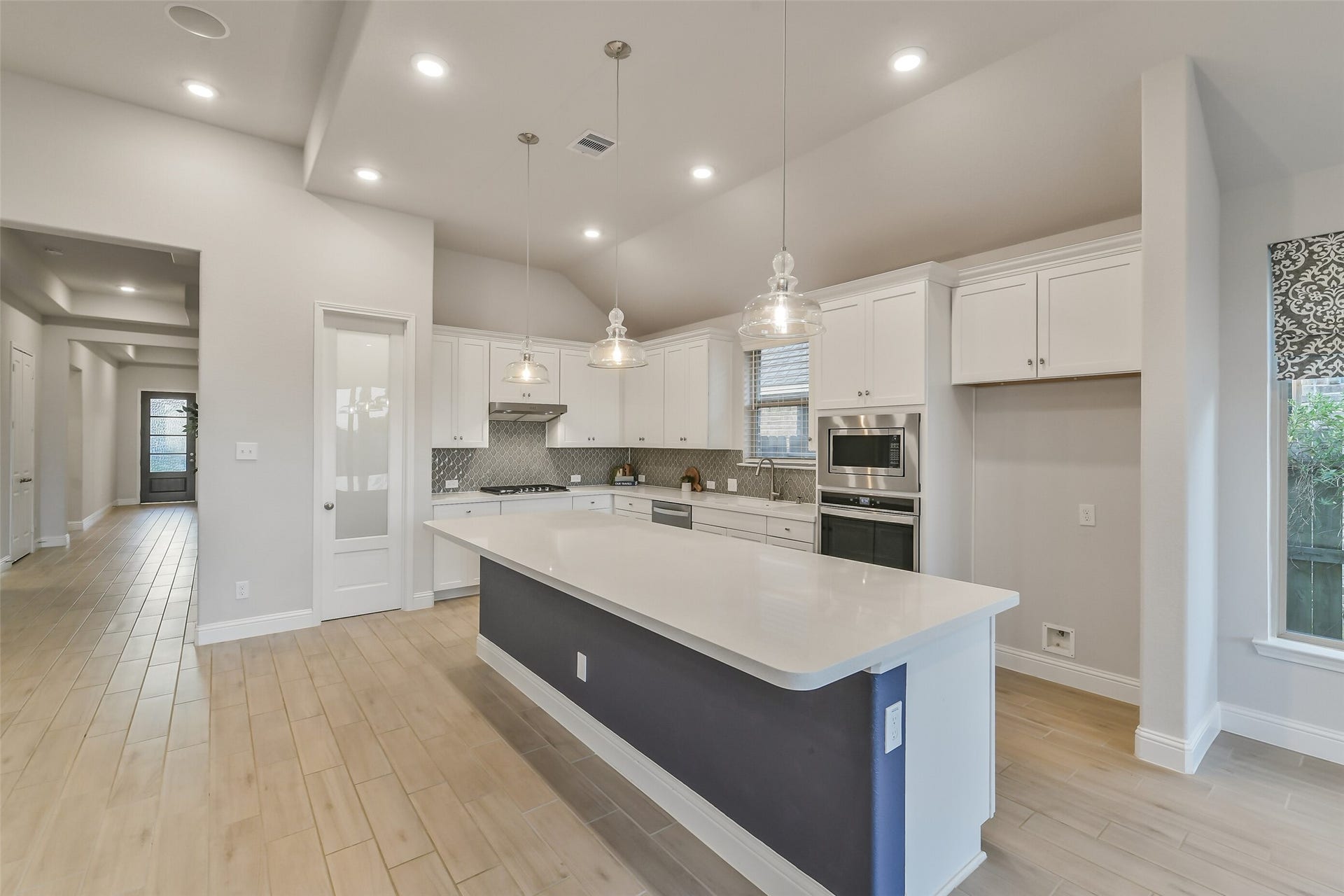 20330 Rose Gray Lane, Tomball, TX 77377 This gorgeous kitchen includes custom lighting, stainless steel appliances, gas oven and stove, designer backsplash, a large walk in pantry, an island, and generous cabinetry.