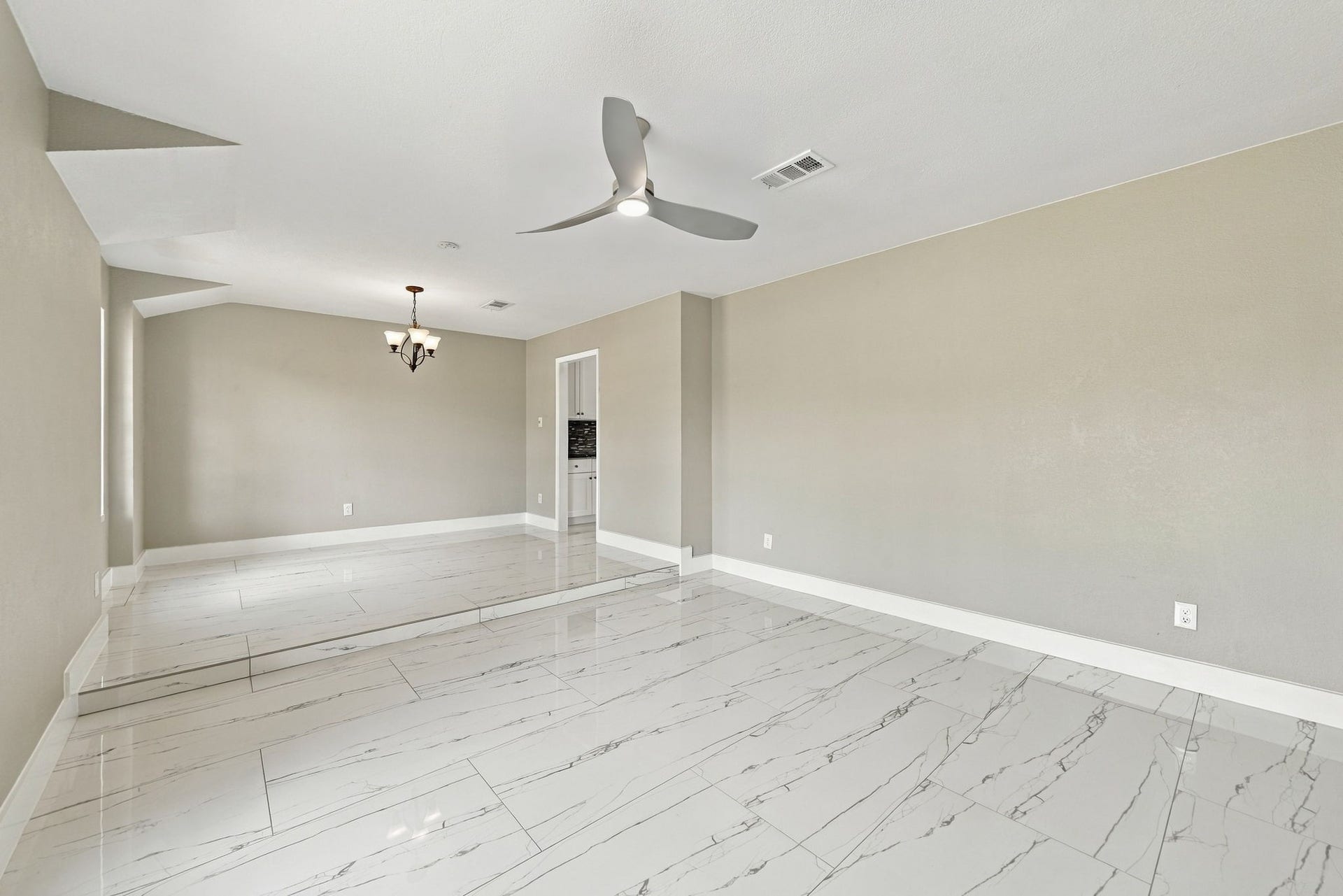 1023 Twinbrooke Drive, Houston, TX 77088 This angle highlights the living areas clean proportions, natural light, and easy connection through the home. Virtually staged.