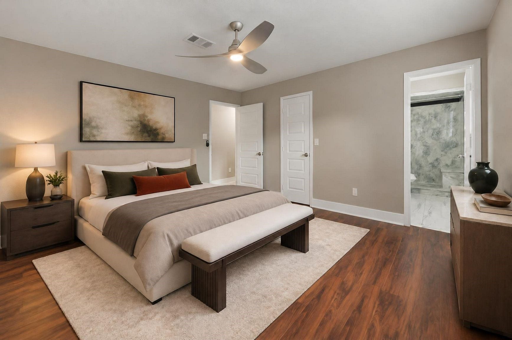 1023 Twinbrooke Drive, Houston, TX 77088 The primary bedroom feels calm and finished with warm flooring, soft light, and a clean retreat-style layout. Virtually staged.