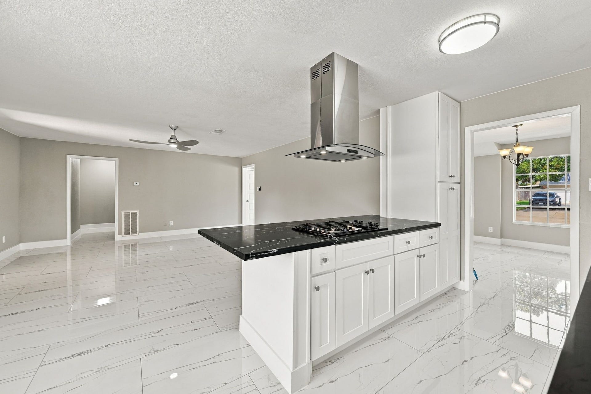 1023 Twinbrooke Drive, Houston, TX 77088 This kitchen view highlights the quartz surfaces, white cabinetry, and clean working layout. Virtually staged.