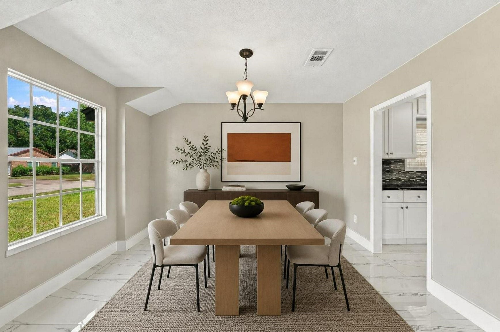 1023 Twinbrooke Drive, Houston, TX 77088 The dining room offers a bright, tailored setting with large windows and a refined place to gather. Virtually staged.