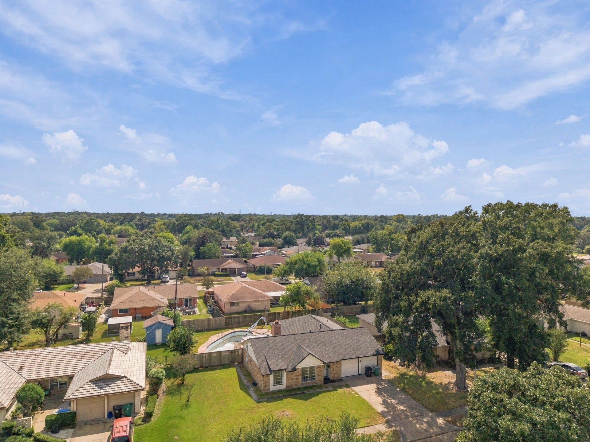 1023 Twinbrooke Drive, Houston, TX 77088 The aerial view gives a broader look at the oversized lot, surrounding homes, and Northwest Houston setting. Virtually staged.