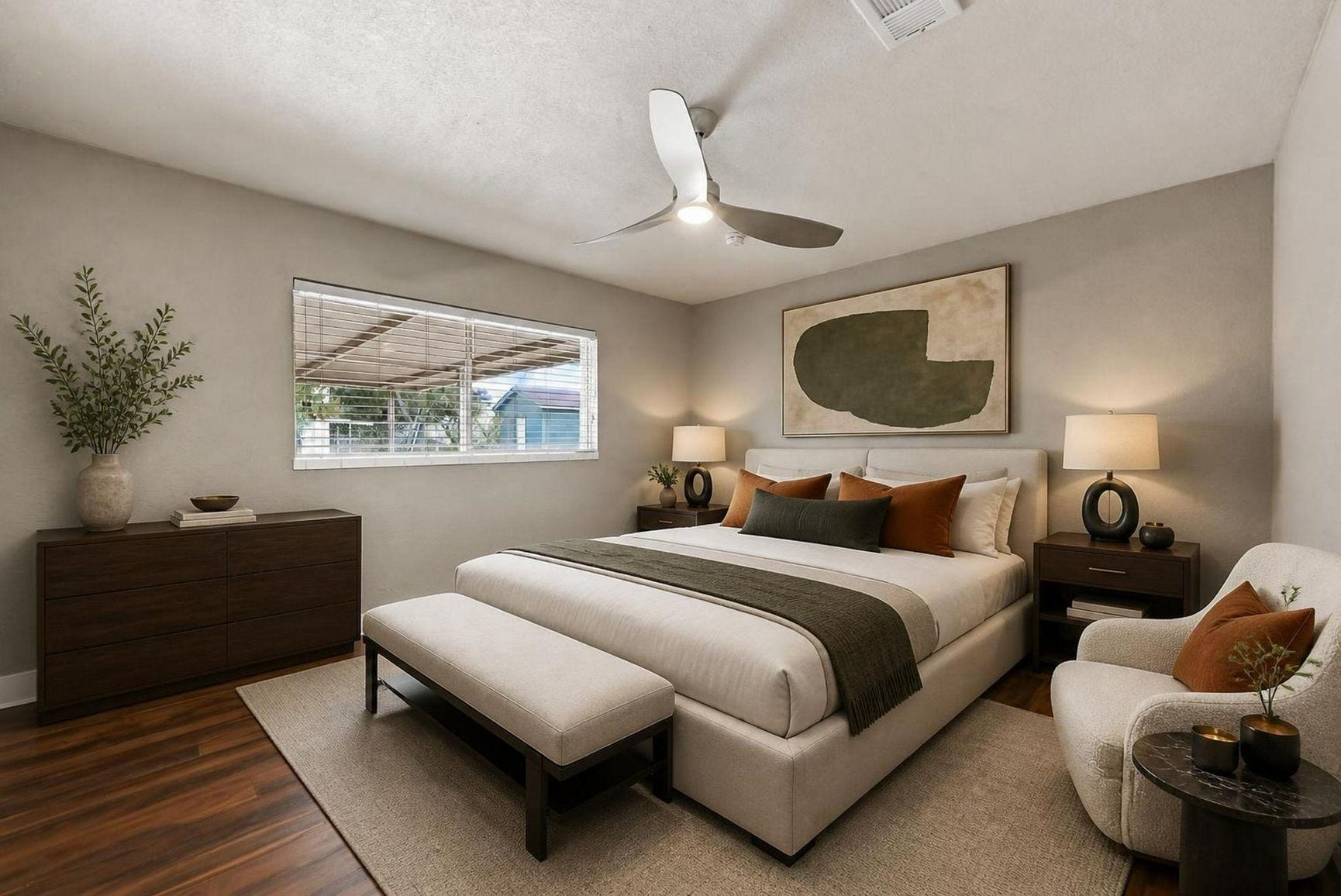 1023 Twinbrooke Drive, Houston, TX 77088 This bedroom feels composed and comfortable with warm flooring, soft bedding, and natural light. Virtually staged.