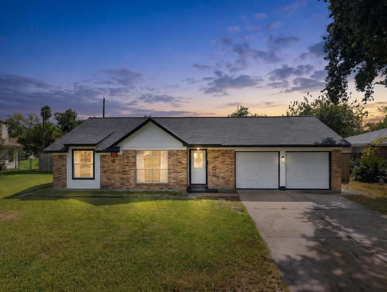 1023 Twinbrooke Drive, Houston, TX 77088 A clean single-story exterior with a wide driveway, attached garage, and soft sunset curb appeal. Virtually staged.