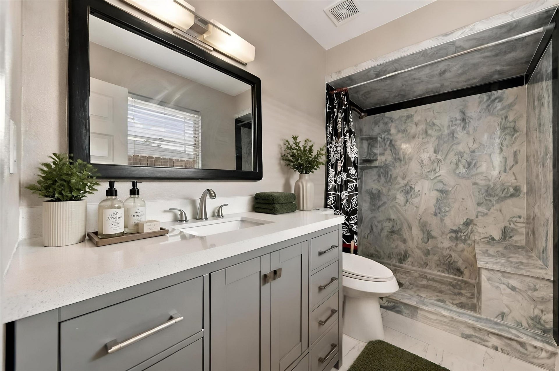 1023 Twinbrooke Drive, Houston, TX 77088 The bathroom brings together a bright vanity, clean finishes, and a sleek shower detail. Virtually staged.