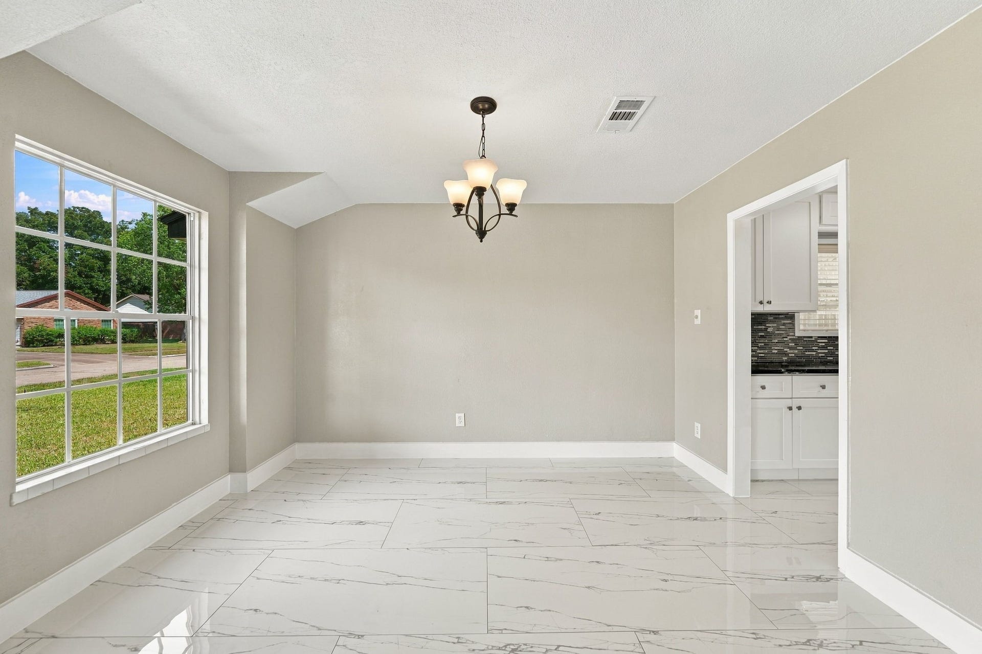 1023 Twinbrooke Drive, Houston, TX 77088 The dining area shows strong natural light, clean tile flooring, and a simple formal layout. Virtually staged.