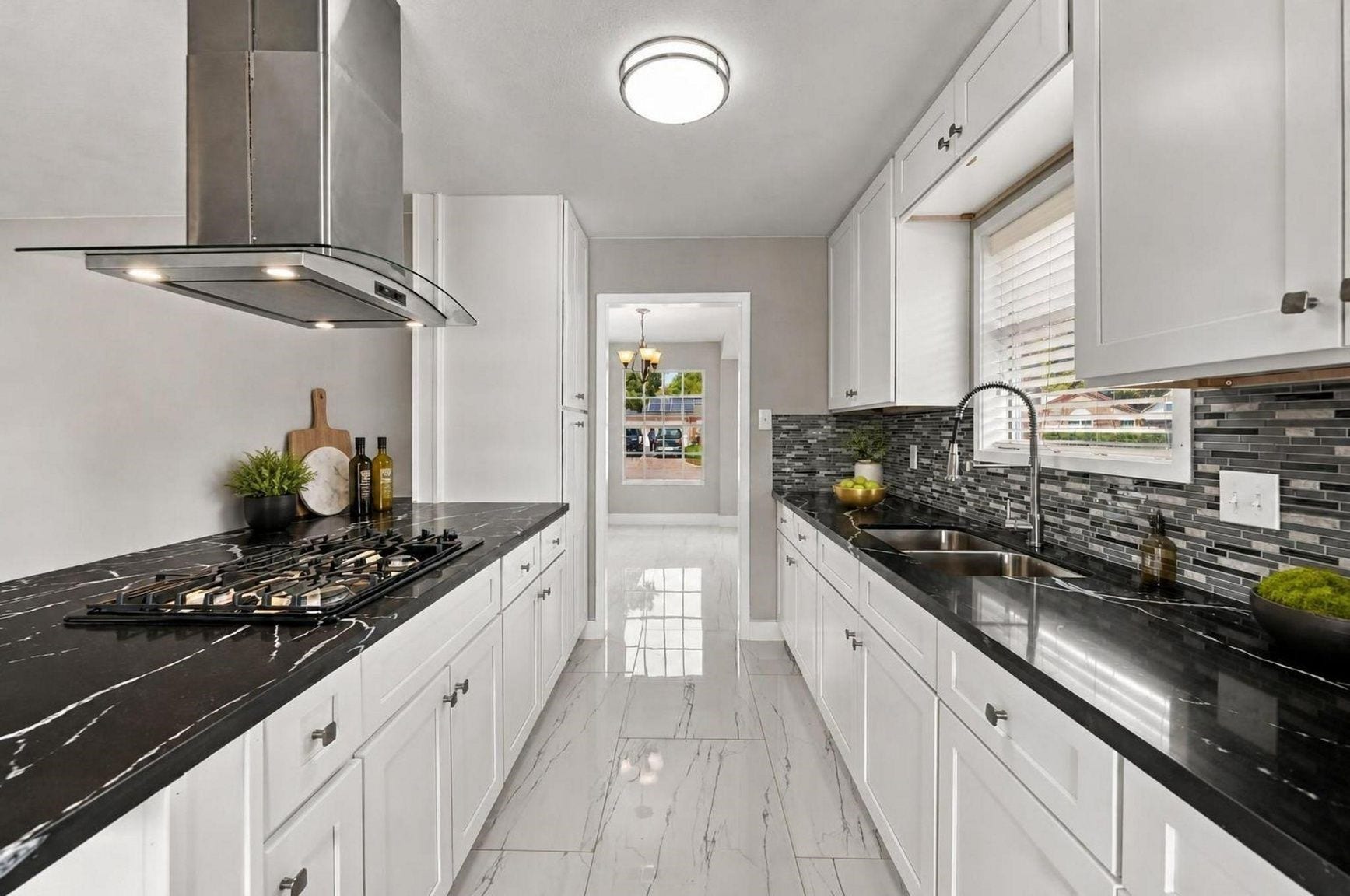 1023 Twinbrooke Drive, Houston, TX 77088 The galley-style kitchen keeps storage, cooking, and prep space arranged in a crisp working line. Virtually staged.