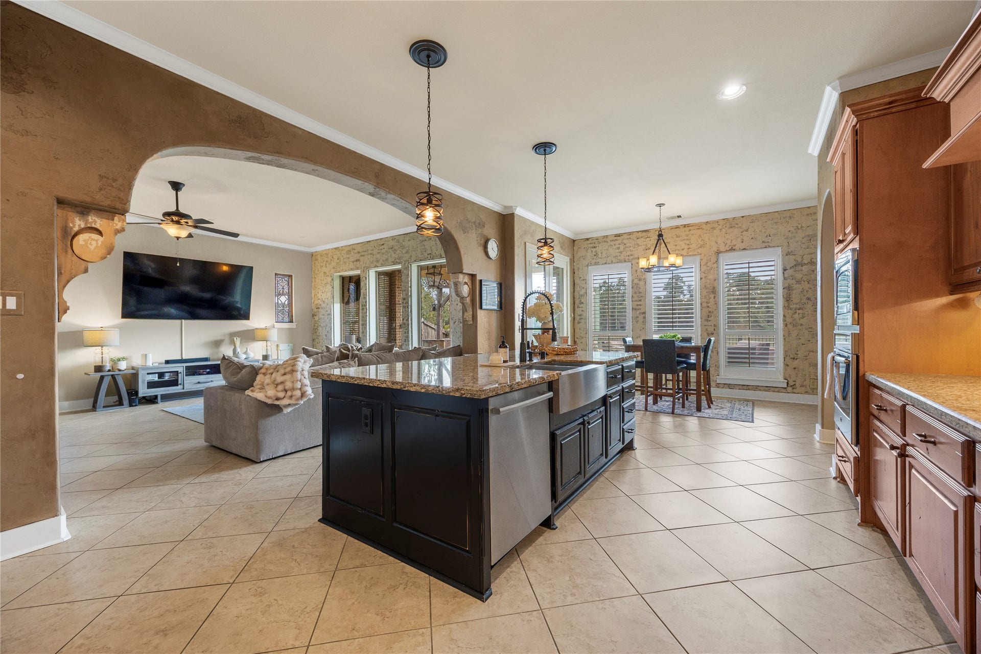 18515 Duke Lake Drive, Spring, TX 77388 The oversized kitchen island anchors this open-concept space, seamlessly connecting the kitchen, breakfast area, and family room.