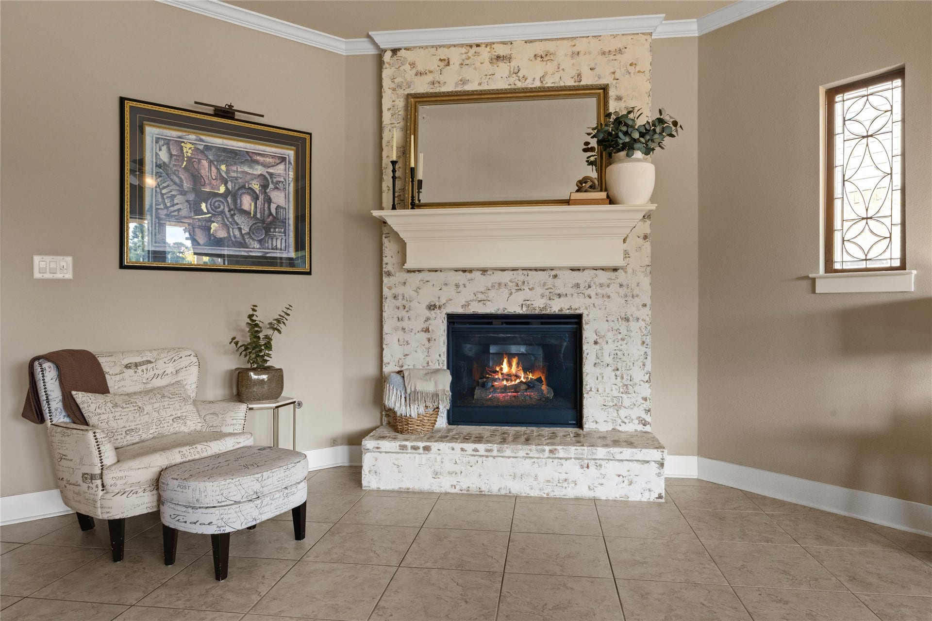 18515 Duke Lake Drive, Spring, TX 77388 The stunning whitewashed brick fireplace serves as a focal point, complemented by a classic white mantel and decorative accent window.
