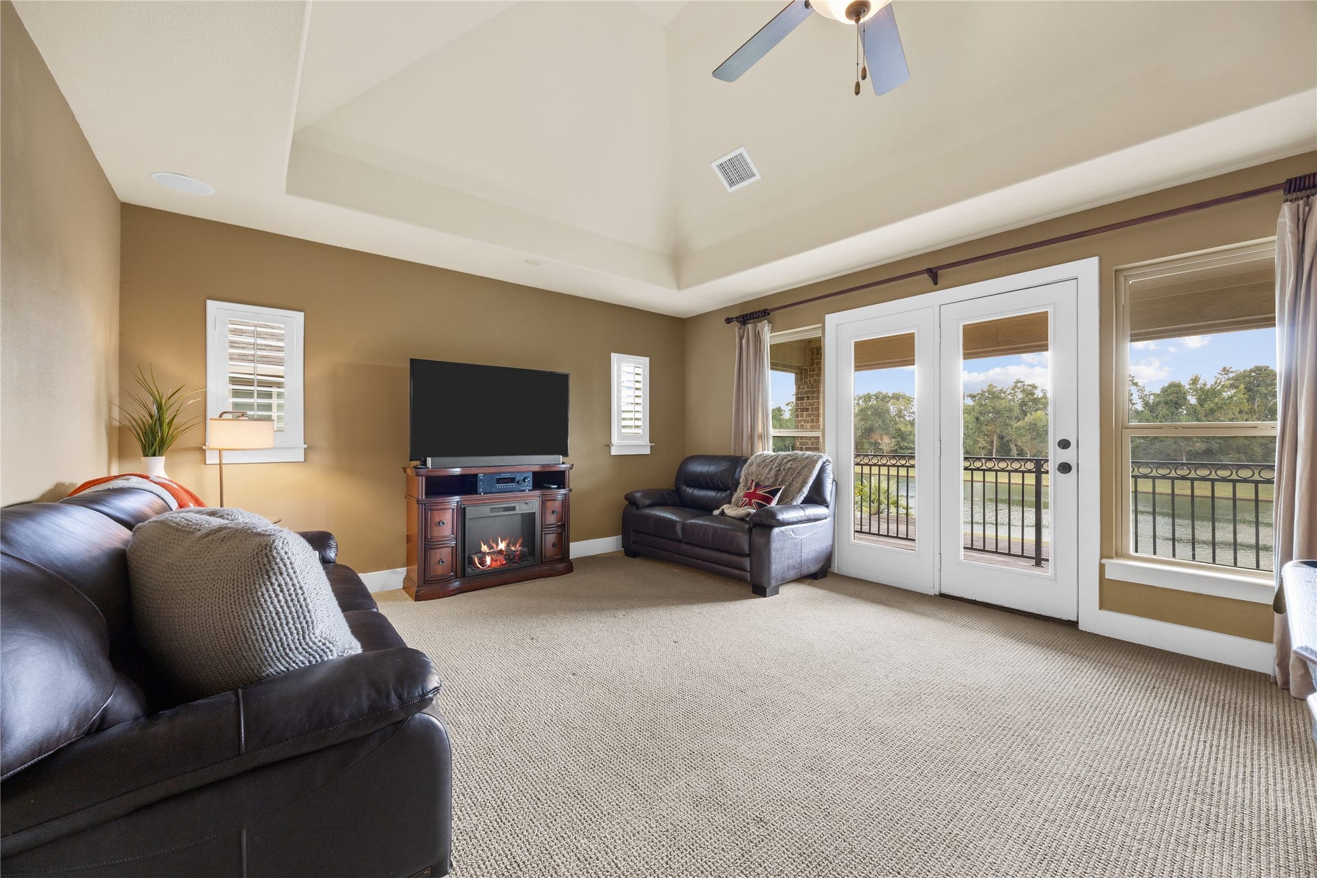 18515 Duke Lake Drive, Spring, TX 77388 A room with a view! The upstairs game room features a soaring ceiling and French doors opening to a covered balcony overlooking the water.