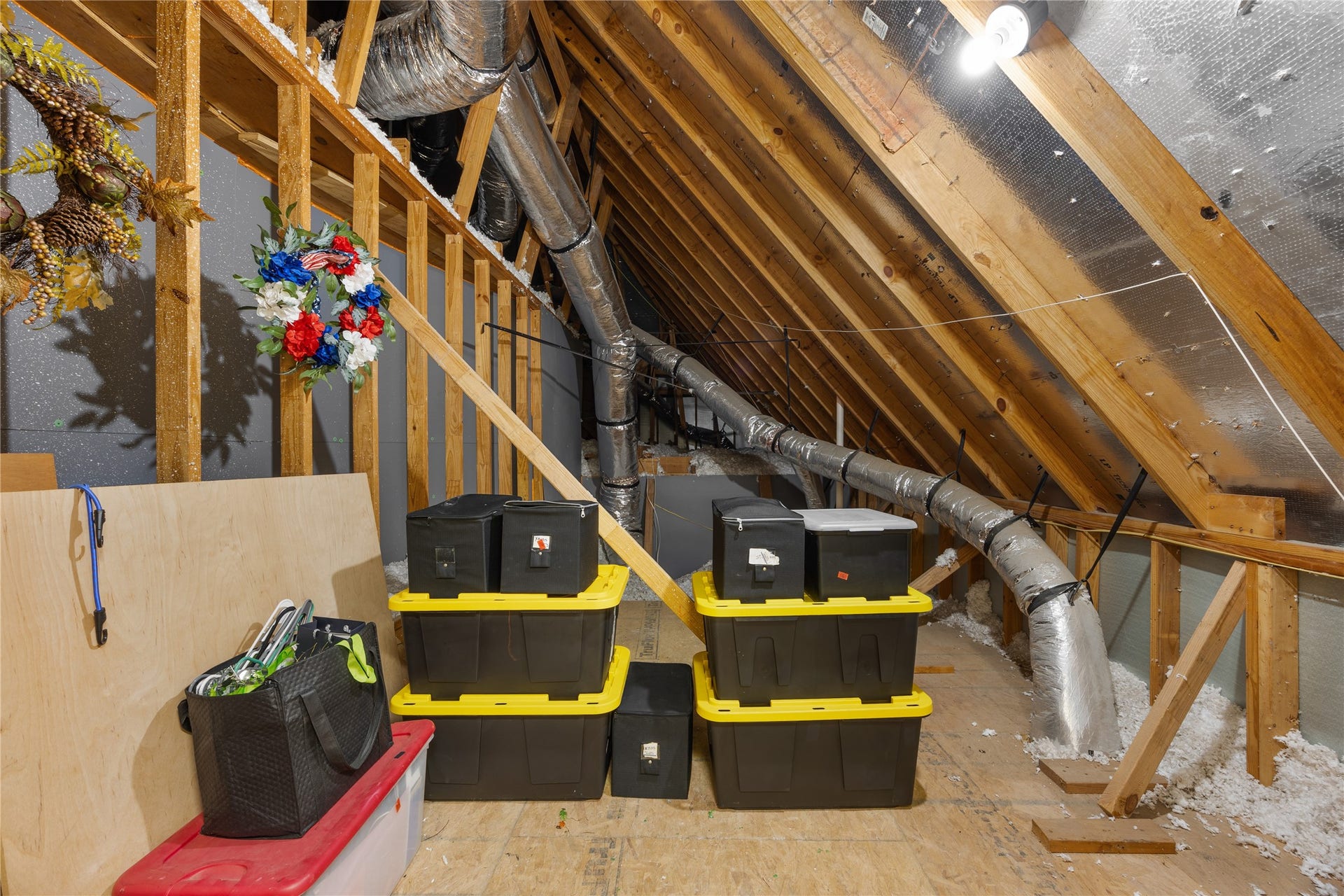 18515 Duke Lake Drive, Spring, TX 77388 One of two additional attic storage spaces with wood decking, lighting, and room to keep seasonal decorations and household items organized.