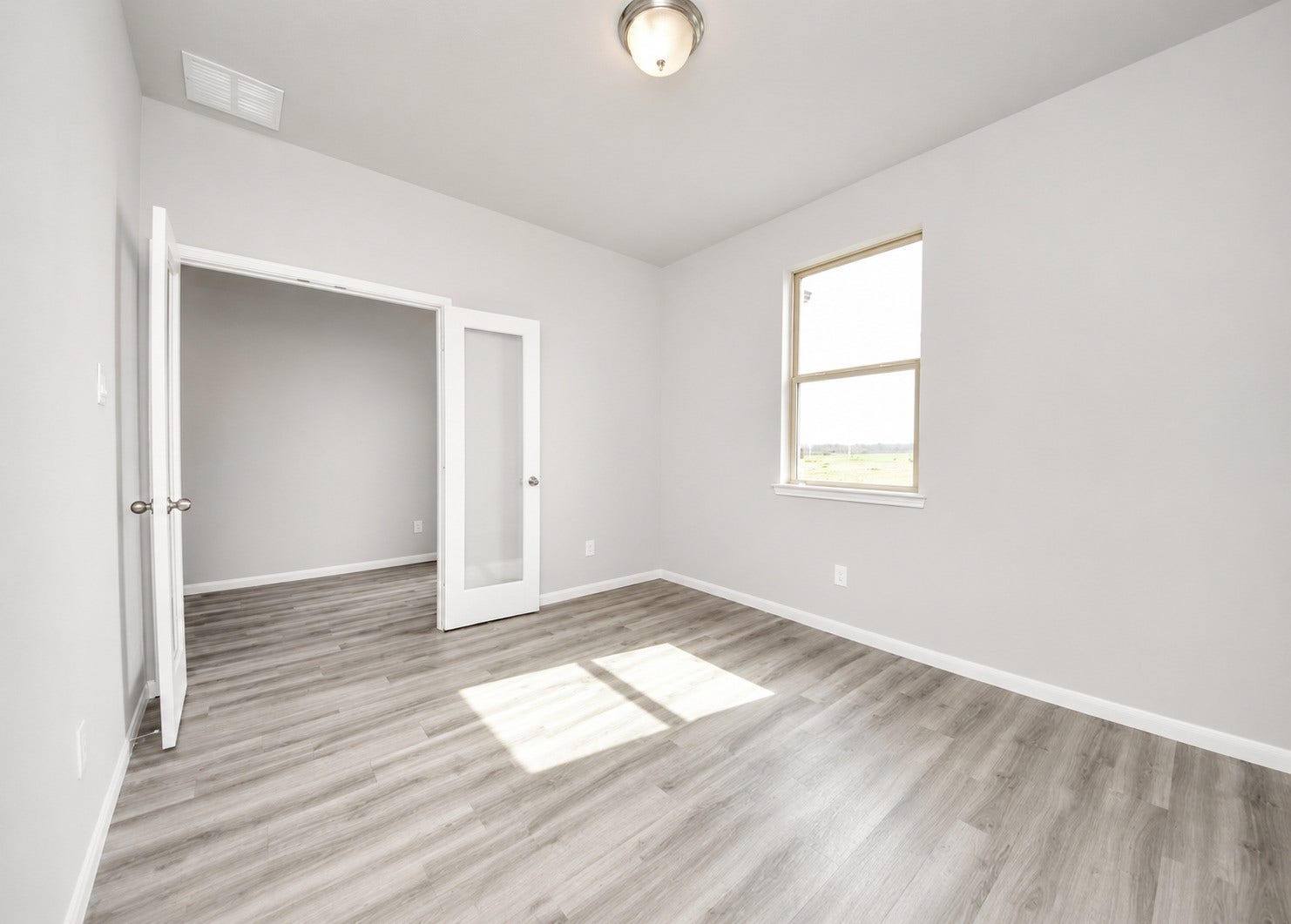 1311 Bonnerjee Drive, Crosby, TX 77532 First floor private home office featuring abundant natural light, neutral finishes, and beautiful wood look flooring. A versatile space ideal for working or studying from home