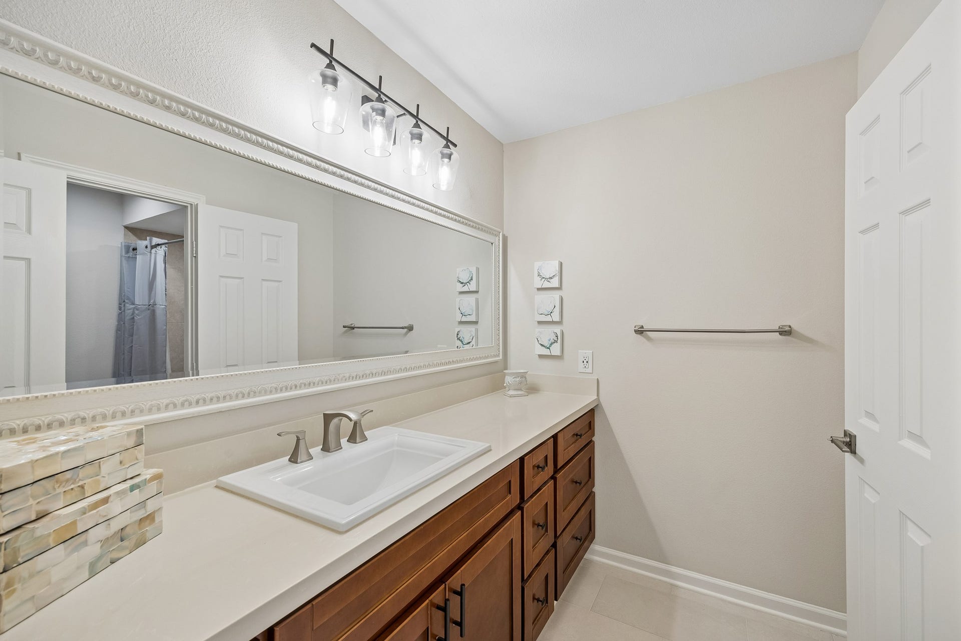 12314 Honeywood Trail, Houston, TX 77077 The hall bathroom features a spacious vanity with a large countertop, generous cabinetry, and an expansive mirror. Through the privacy door is the tub/shower combo, toilet, and a dedicated linen closet.