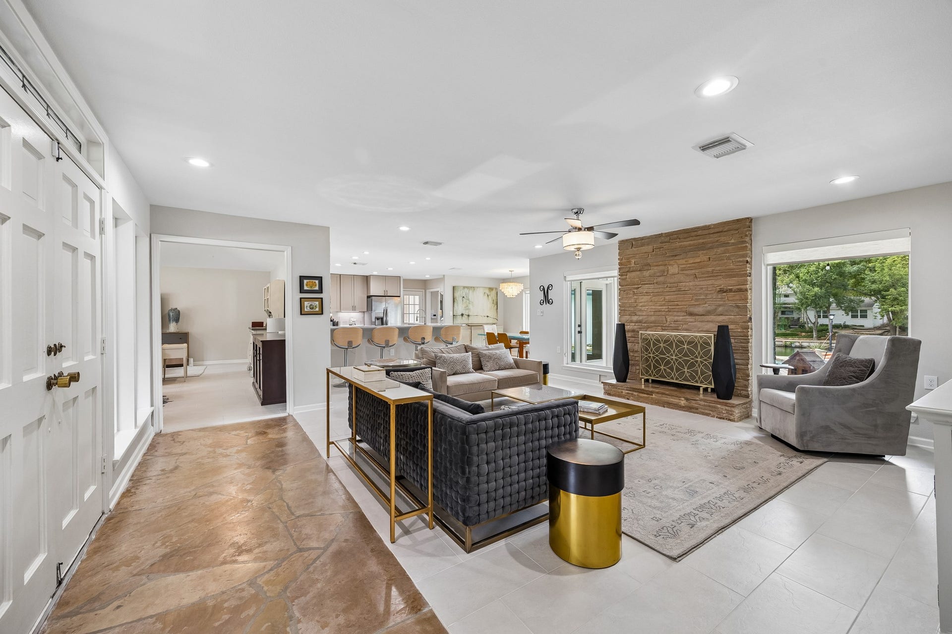 12314 Honeywood Trail, Houston, TX 77077 Step through the entry doors into a welcoming living room anchored by a striking original stacked stone fireplace. Original stone floors meet newly tiled flooring that flows throughout the home, while a stylish ceiling fan adds a nice touch.
