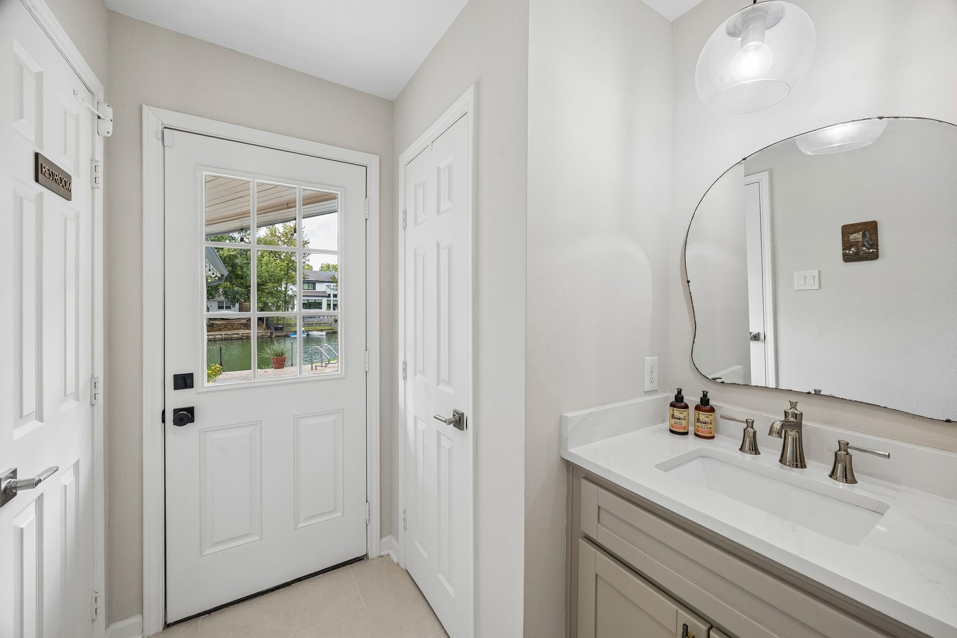 12314 Honeywood Trail, Houston, TX 77077 Convenient hallway featuring a storage closet, the half bath, and direct access to the backyard.