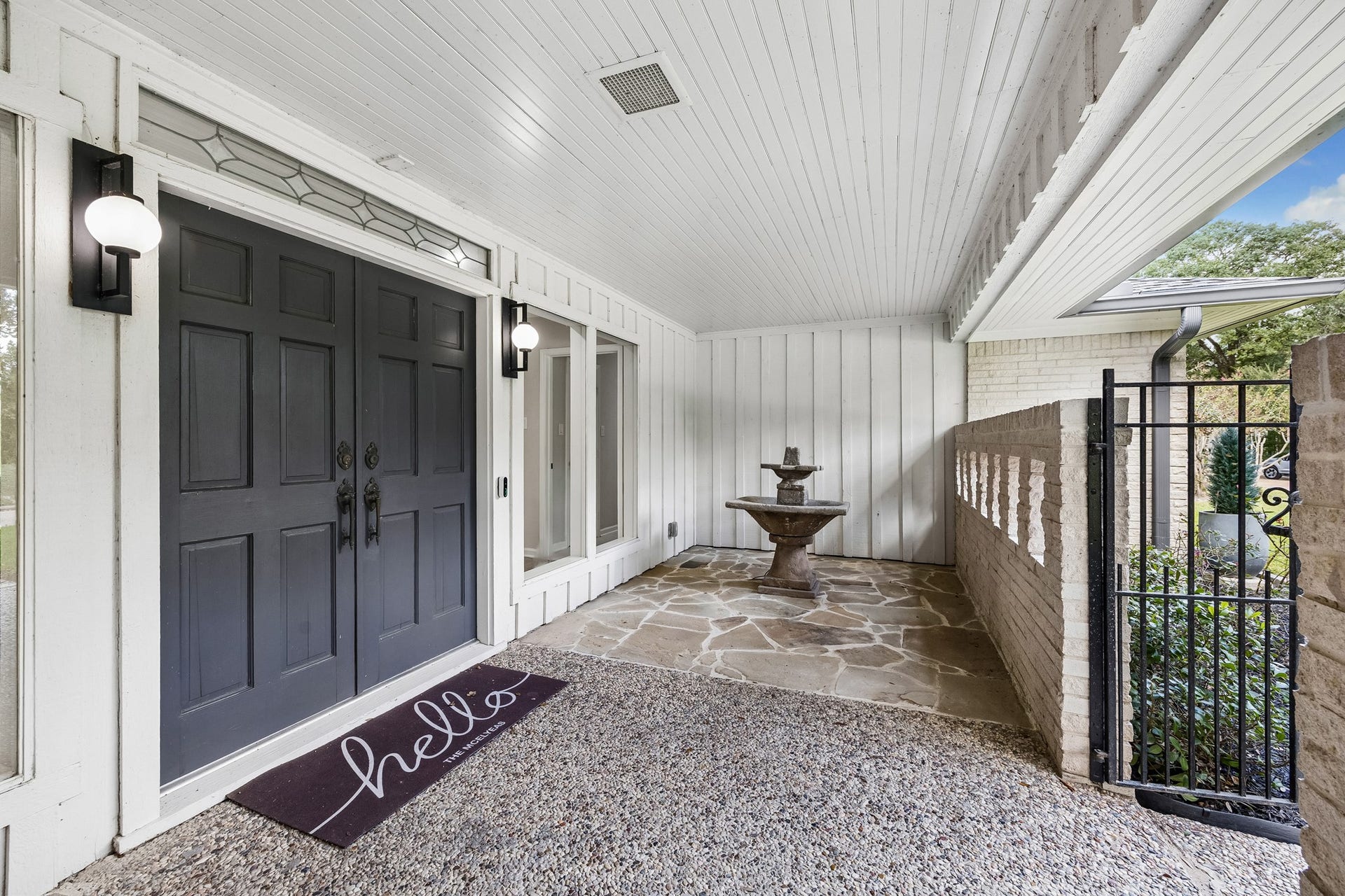12314 Honeywood Trail, Houston, TX 77077 An enclosed gated porch with double entry doors and generous plate glass windows makes this space feel like part of the indoors and part of the outdoors.