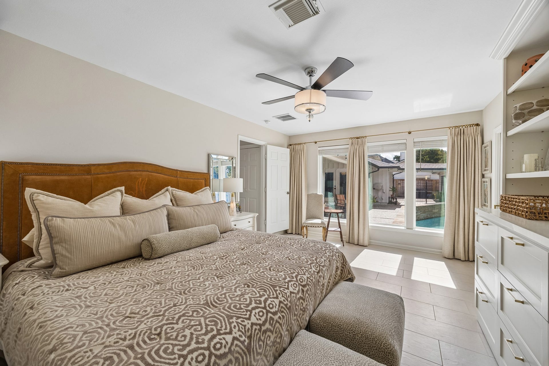 12314 Honeywood Trail, Houston, TX 77077 Spacious Primary Bedroom featuring large windows overlooking the pool. Abundant natural light creates a relaxing atmosphere.