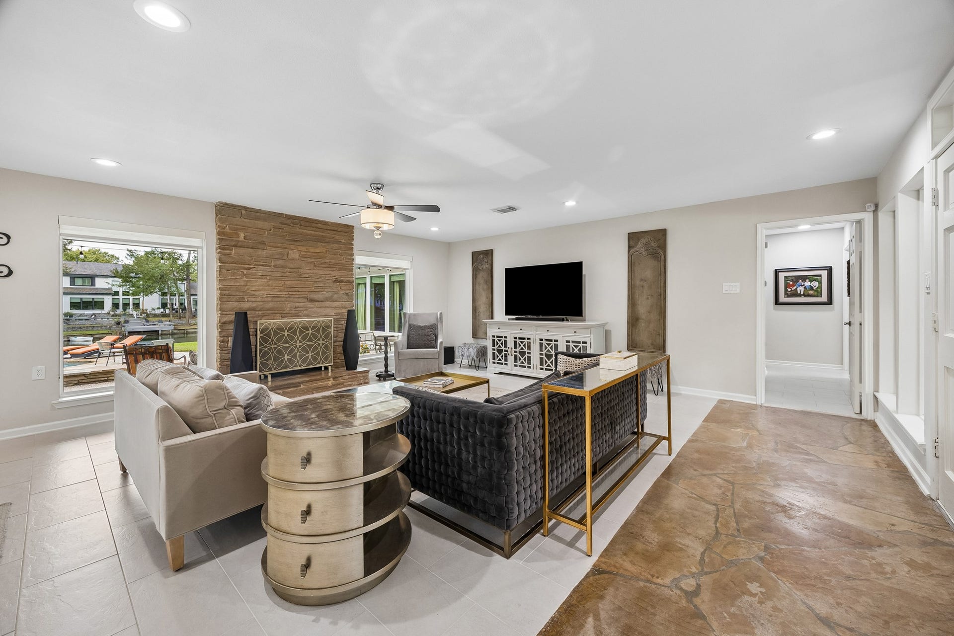 12314 Honeywood Trail, Houston, TX 77077 The windows flanking the fireplace provide lovely views of the pool and lake. To the right of the entry, a hallway leads toward the bedrooms, keeping the sleeping space private and quiet. The tile flooring continues down the hall.