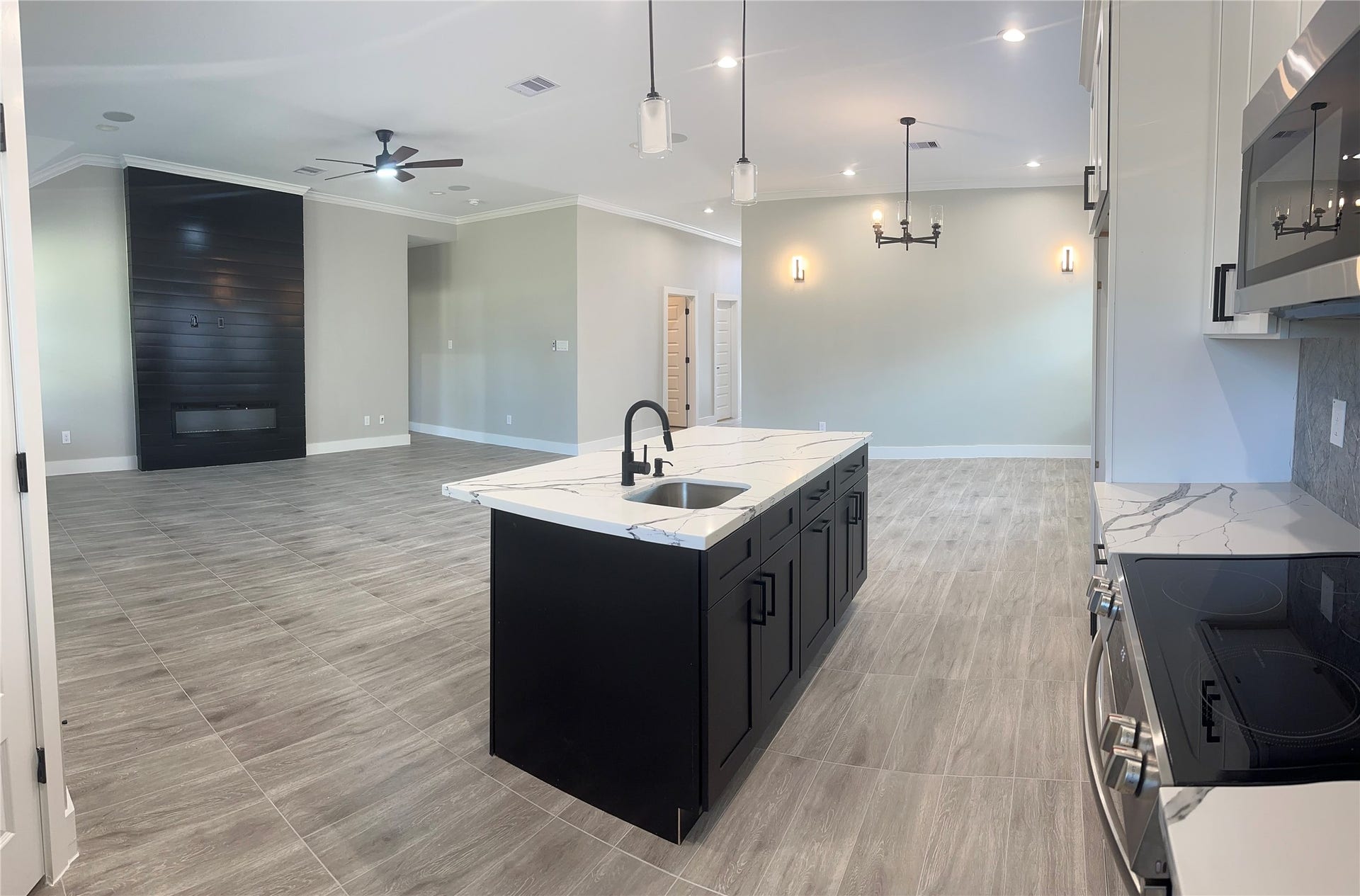 630 Ezekiel Smith Street, Prairie View, TX 77484 Another view of the huge Kitchen with the Family and Dining area. The large beautiful electric fireplace
